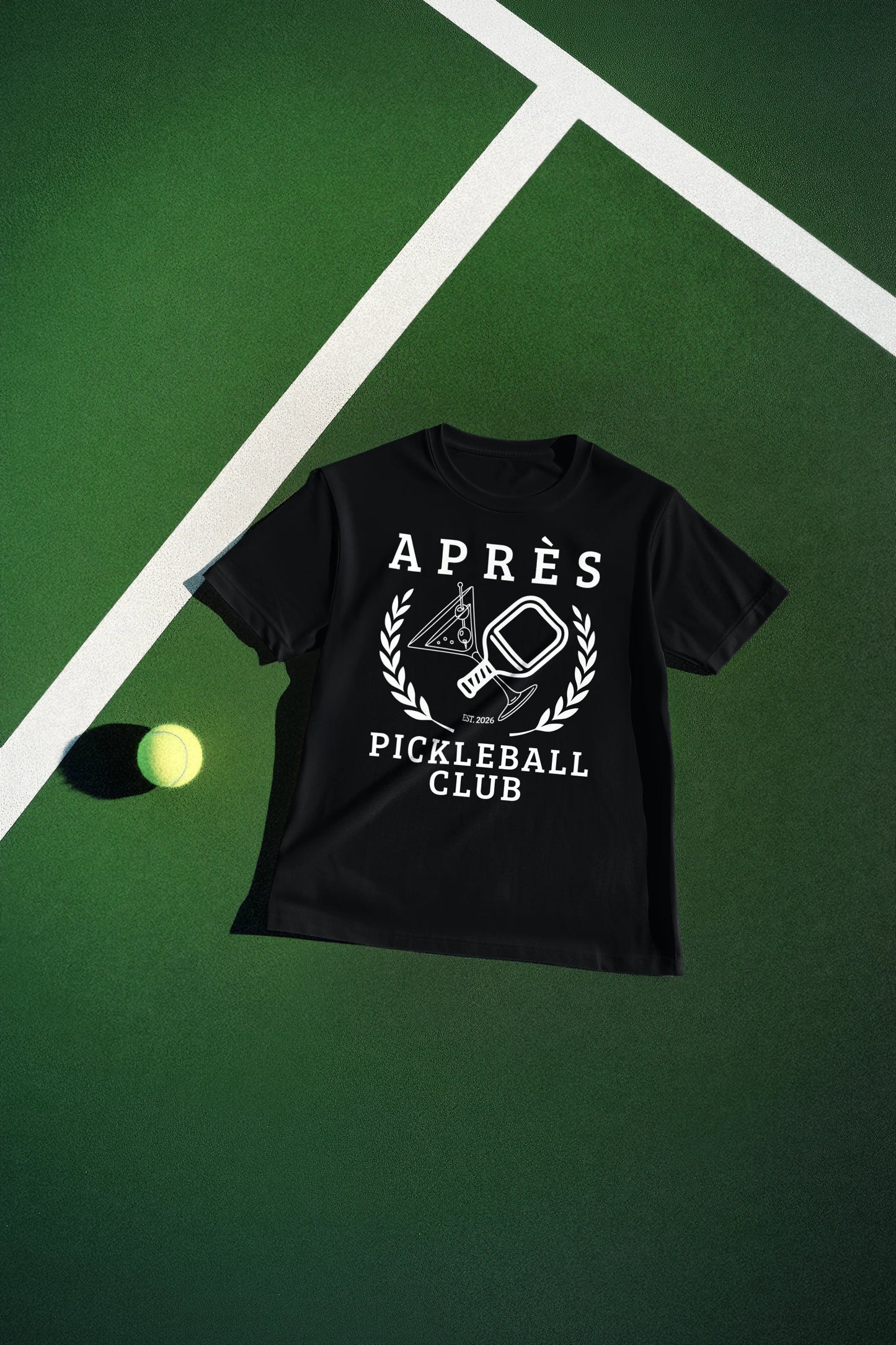 Funny Pickleball Shirt Black t-shirt with 'Apres Pickleball Club' design on a green surface