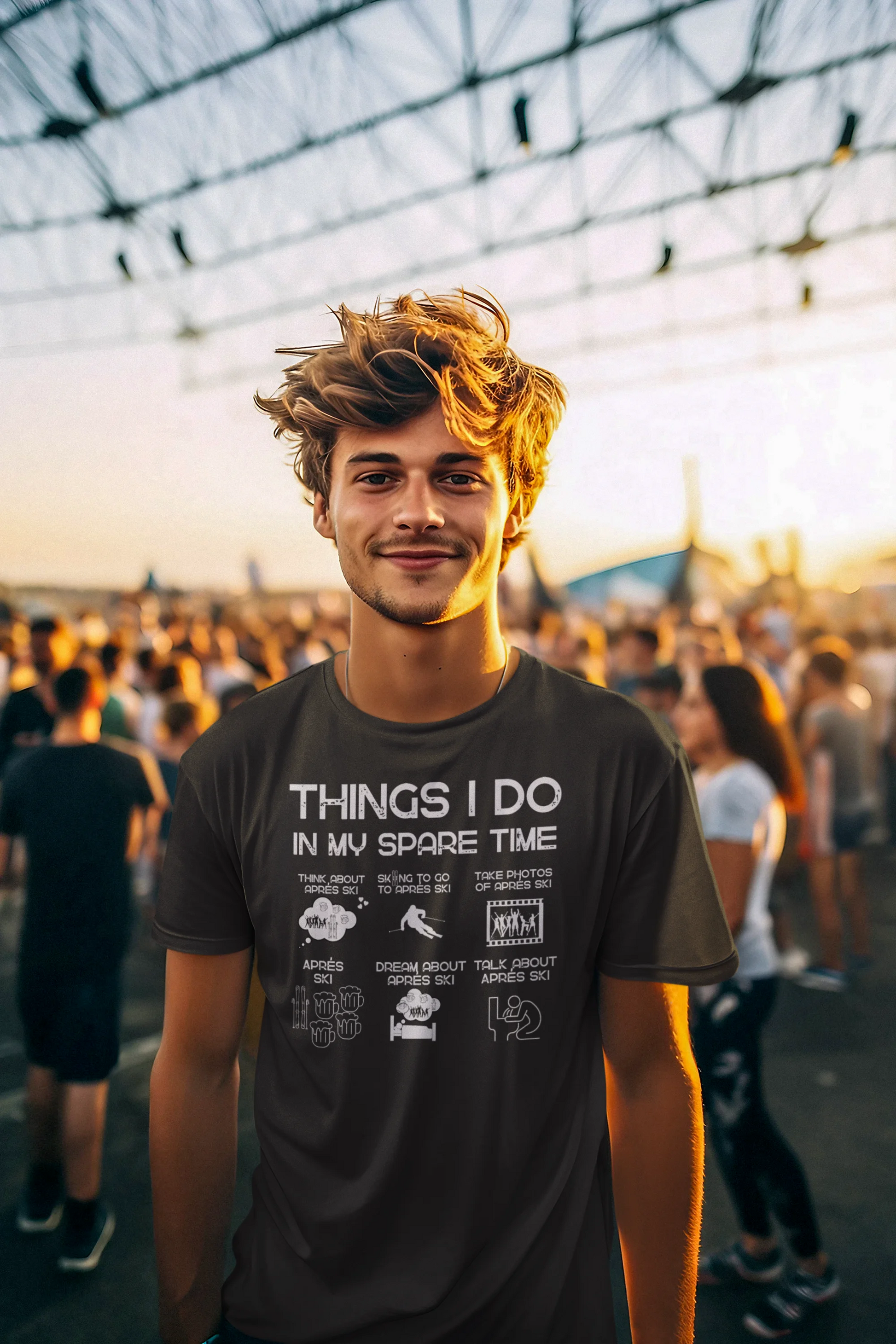 Man wearing a t-shirt with text and graphics in an outdoor setting with people and structures in the background.