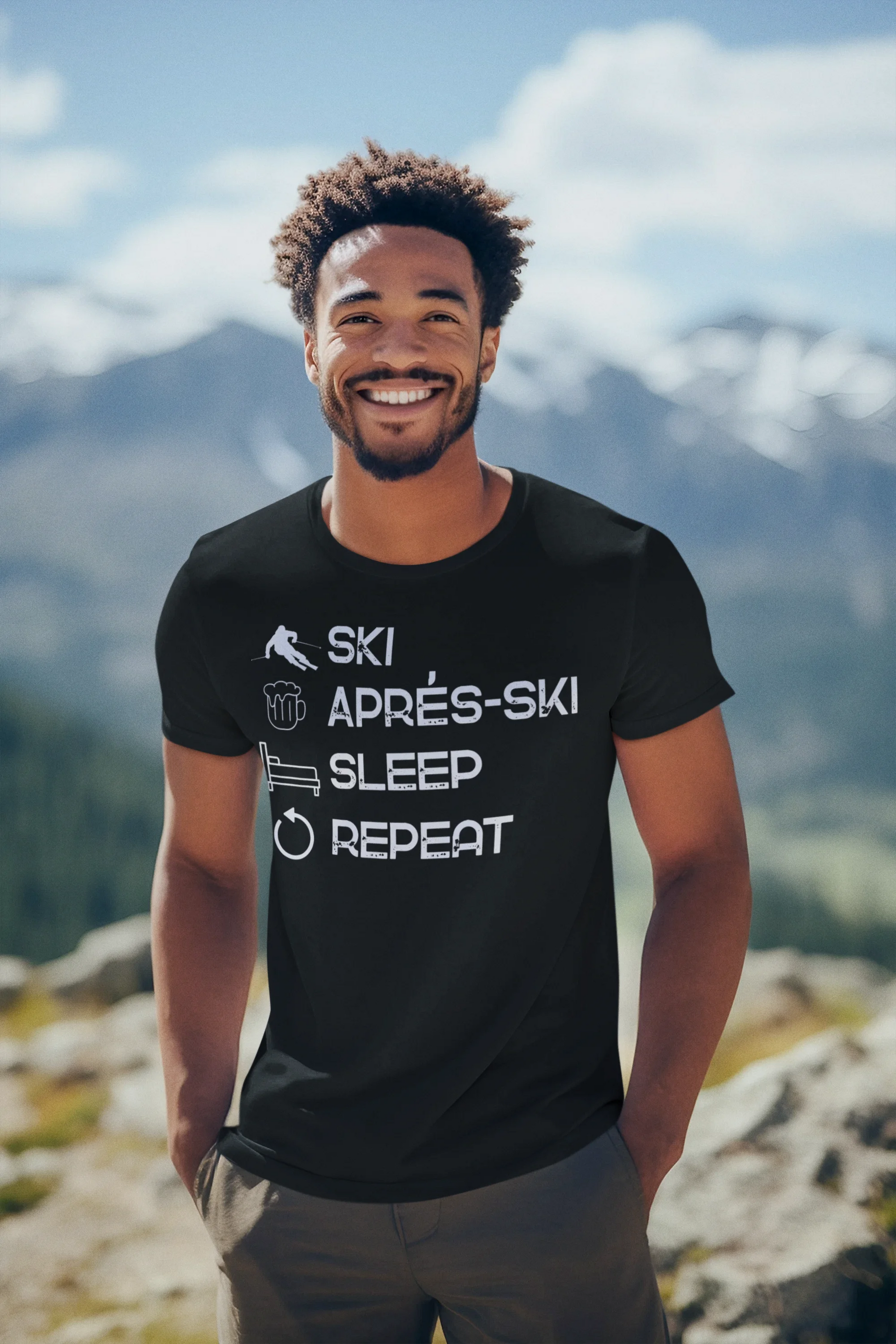 Man wearing a black t-shirt with text standing on a mountain