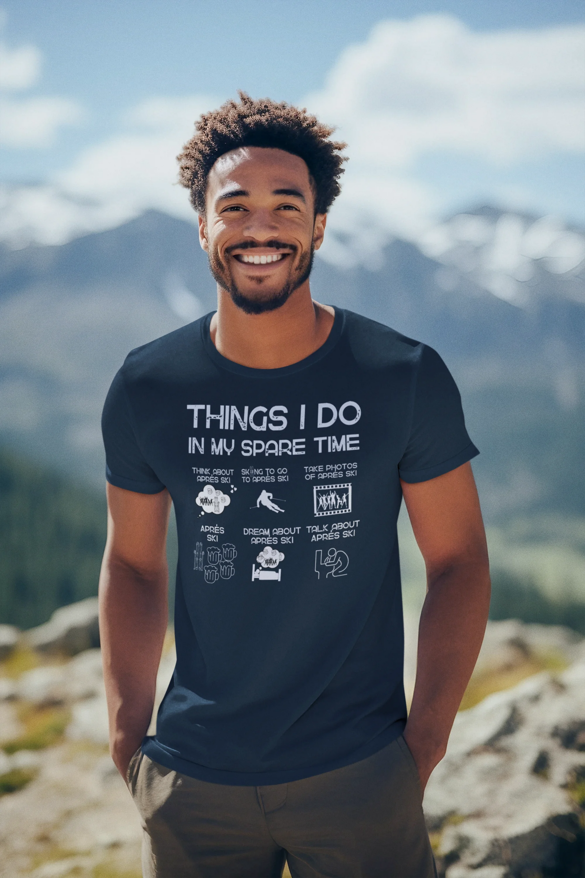 Man wearing a t-shirt with text and graphics on a mountain background