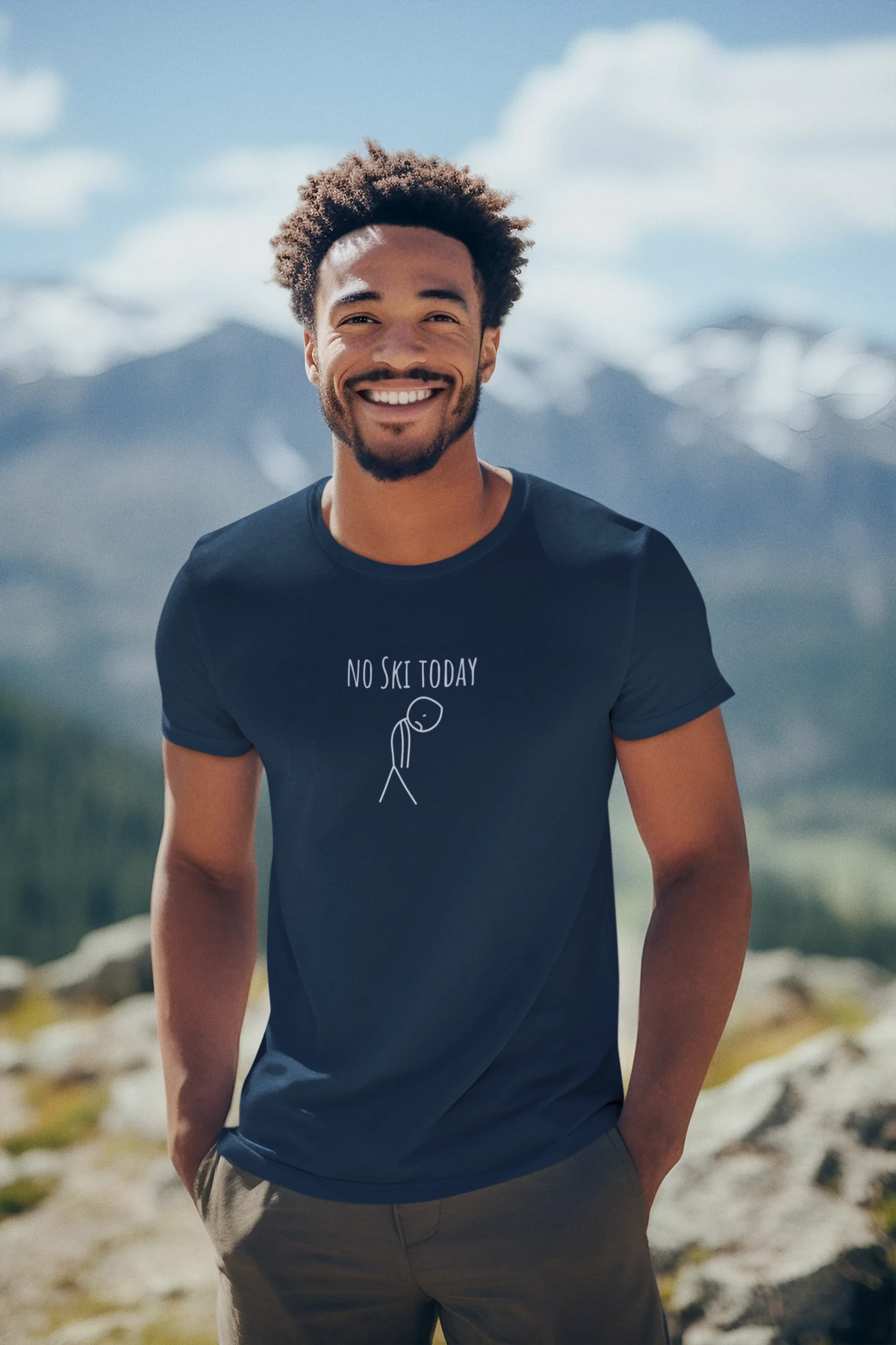 Man wearing a navy blue t-shirt with 'No Ski Today' text and graphic, standing on a mountain.