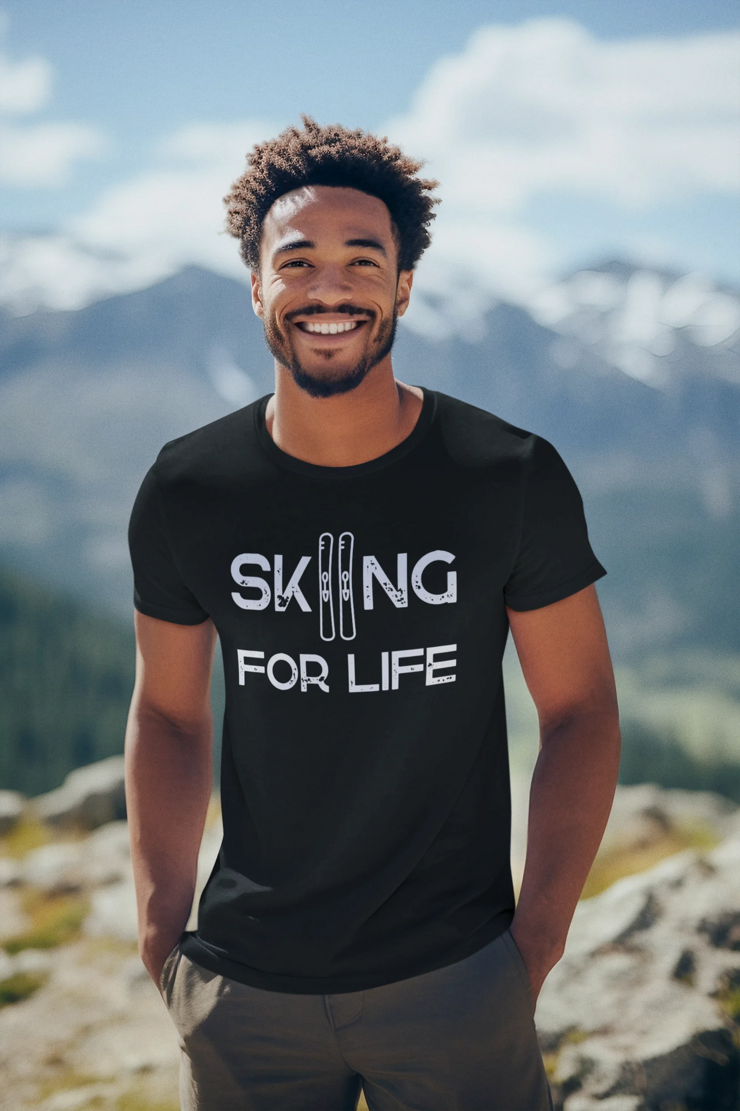 Man wearing a black t-shirt with 'Skiing for Life' text on a mountain background