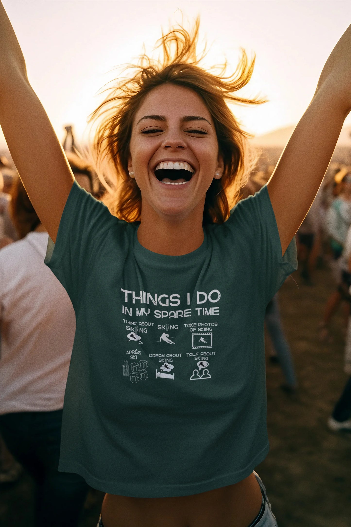 Person wearing a green t-shirt with text, standing outdoors with arms raised.
