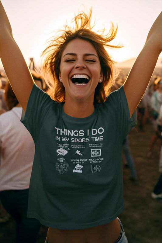 Person wearing a t-shirt with text and graphics, standing outdoors with arms raised.