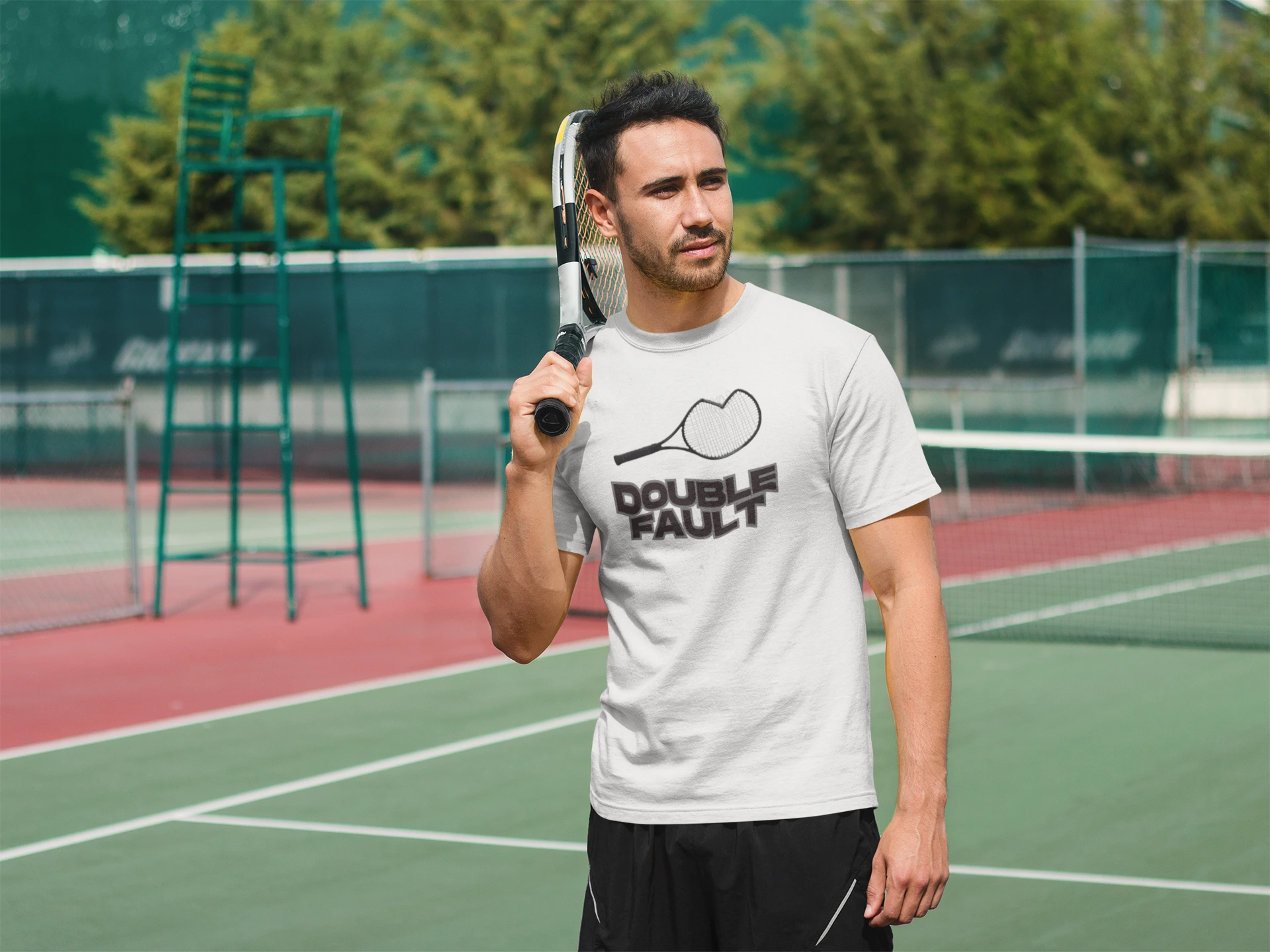 Double Fault Tee Man holding a tennis racket on a tennis court wearing a 'Double Fault' t-shirt.