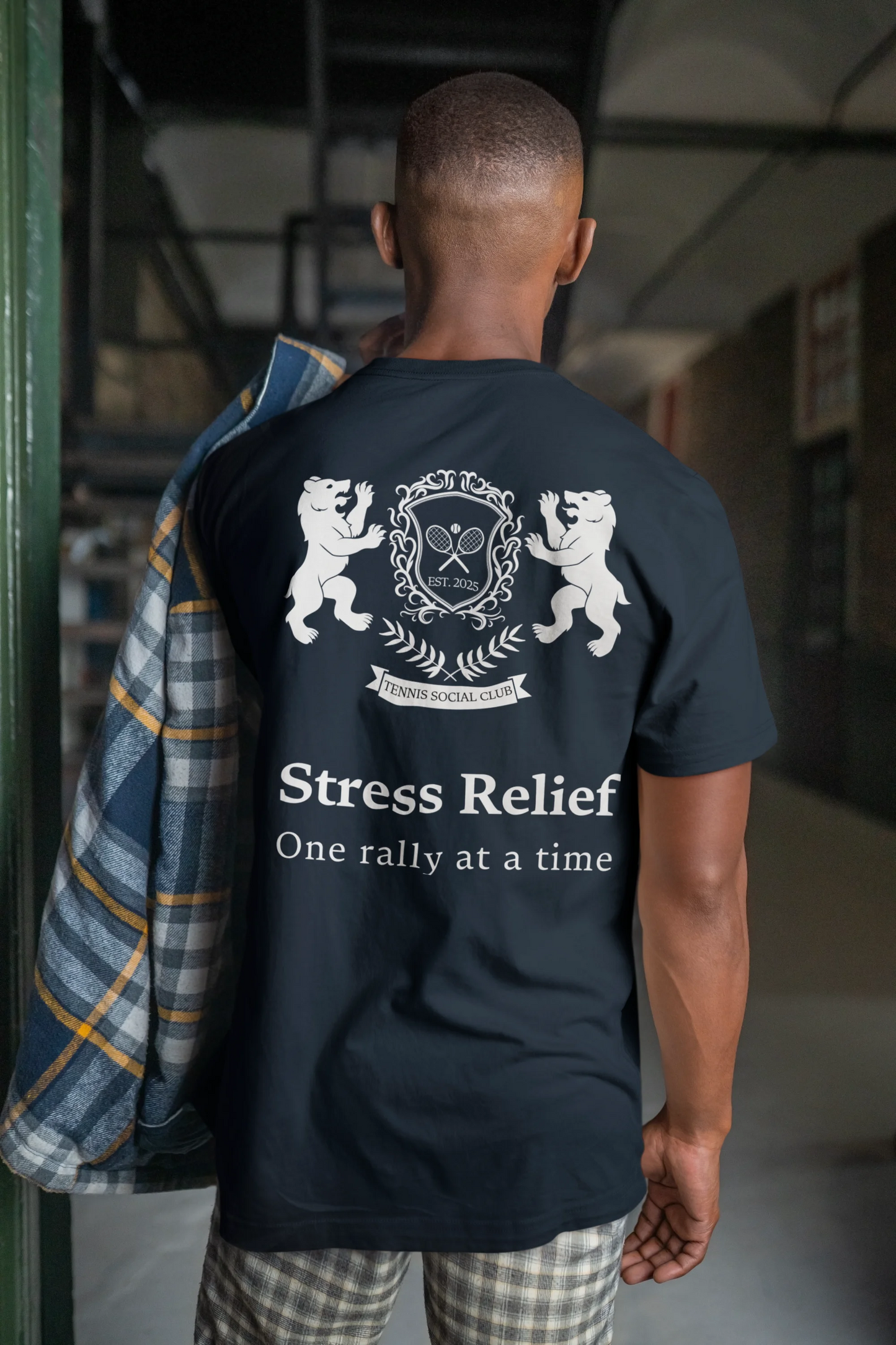 Person wearing a black t-shirt with 'Stress Relief One rally at a time' text and logo on the back.