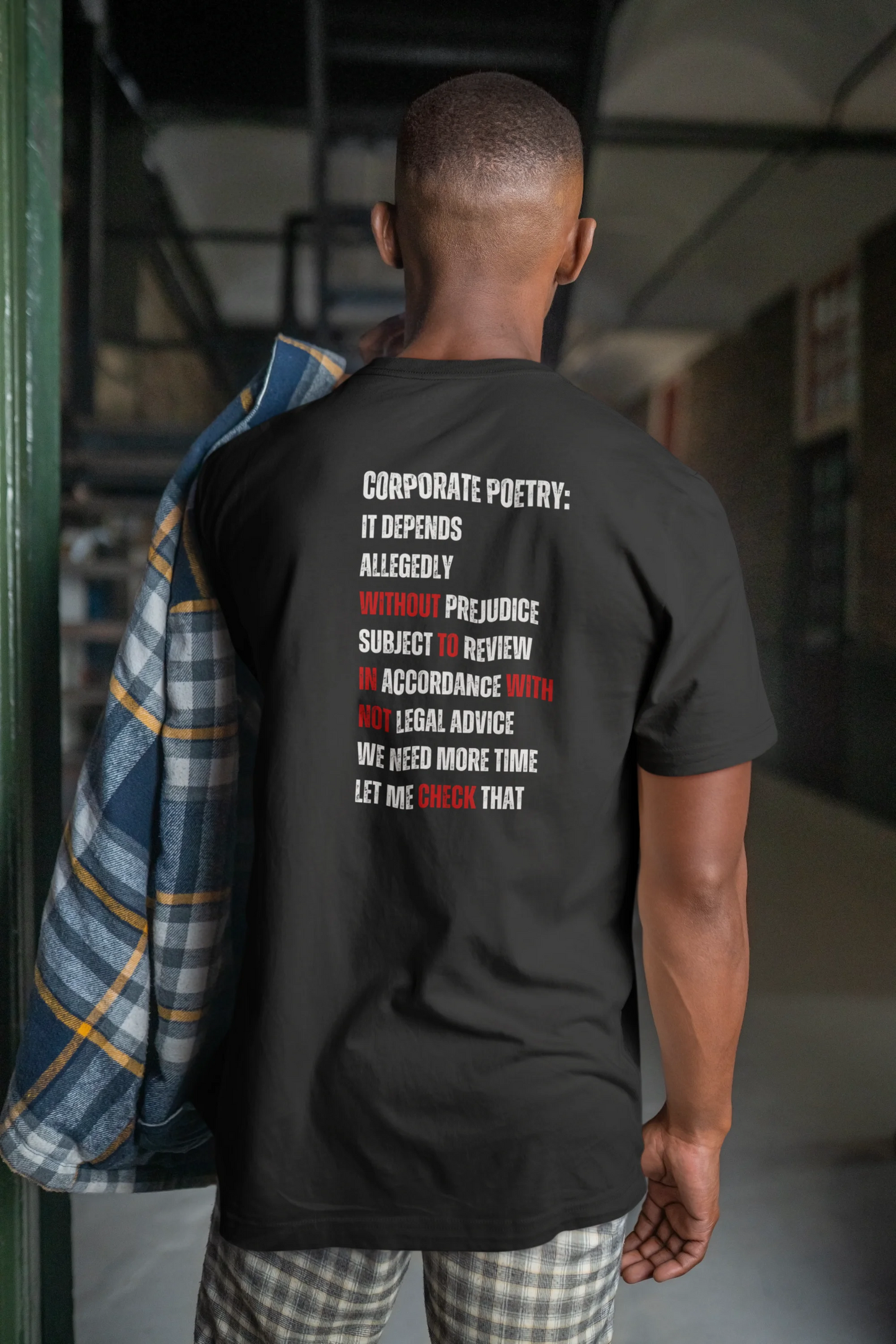 Funny Lawyer Shirt Person wearing a black t-shirt with text on the back in an indoor setting