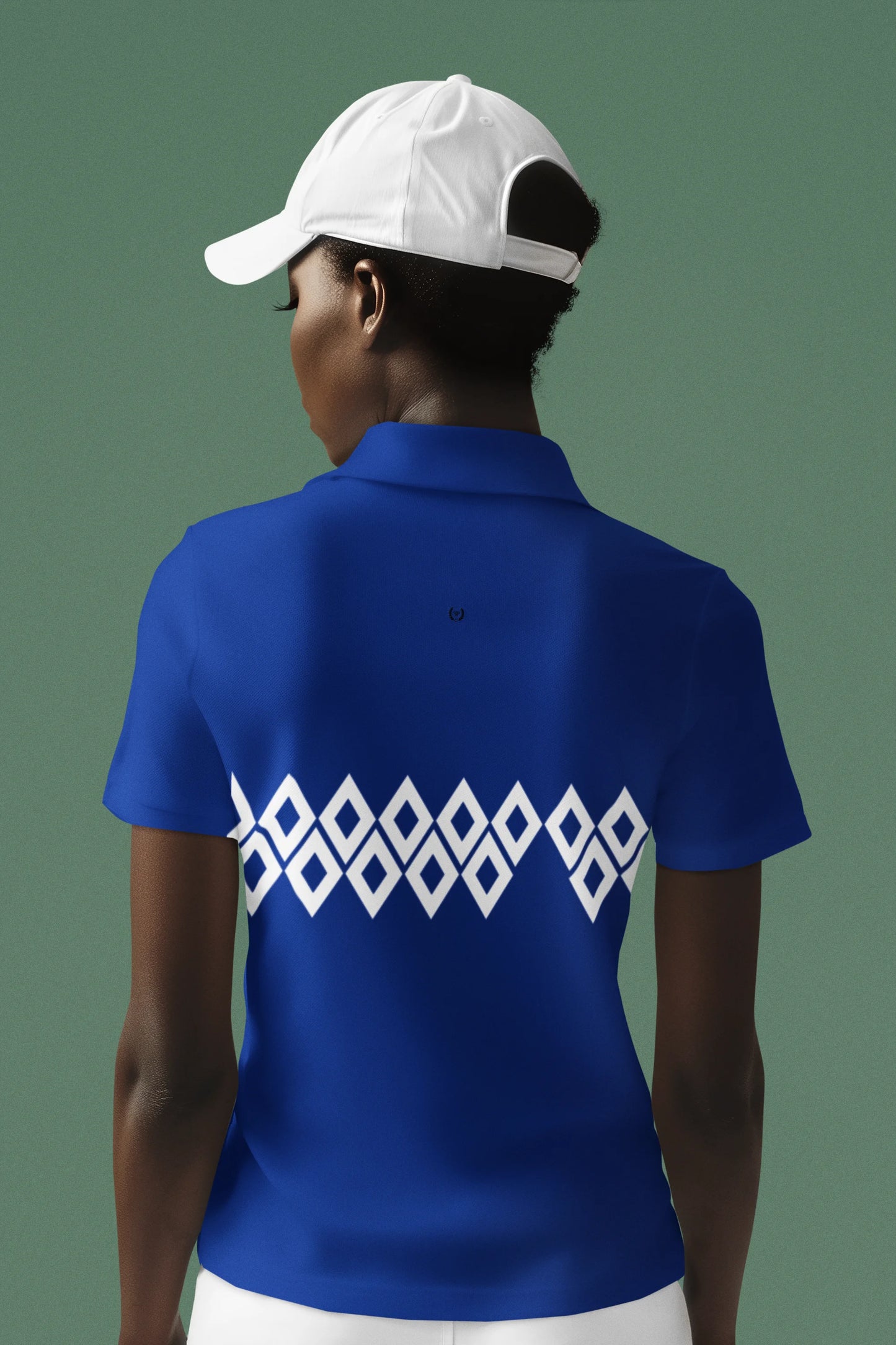 Person wearing a blue polo shirt with a white geometric pattern on the back, against a green background.