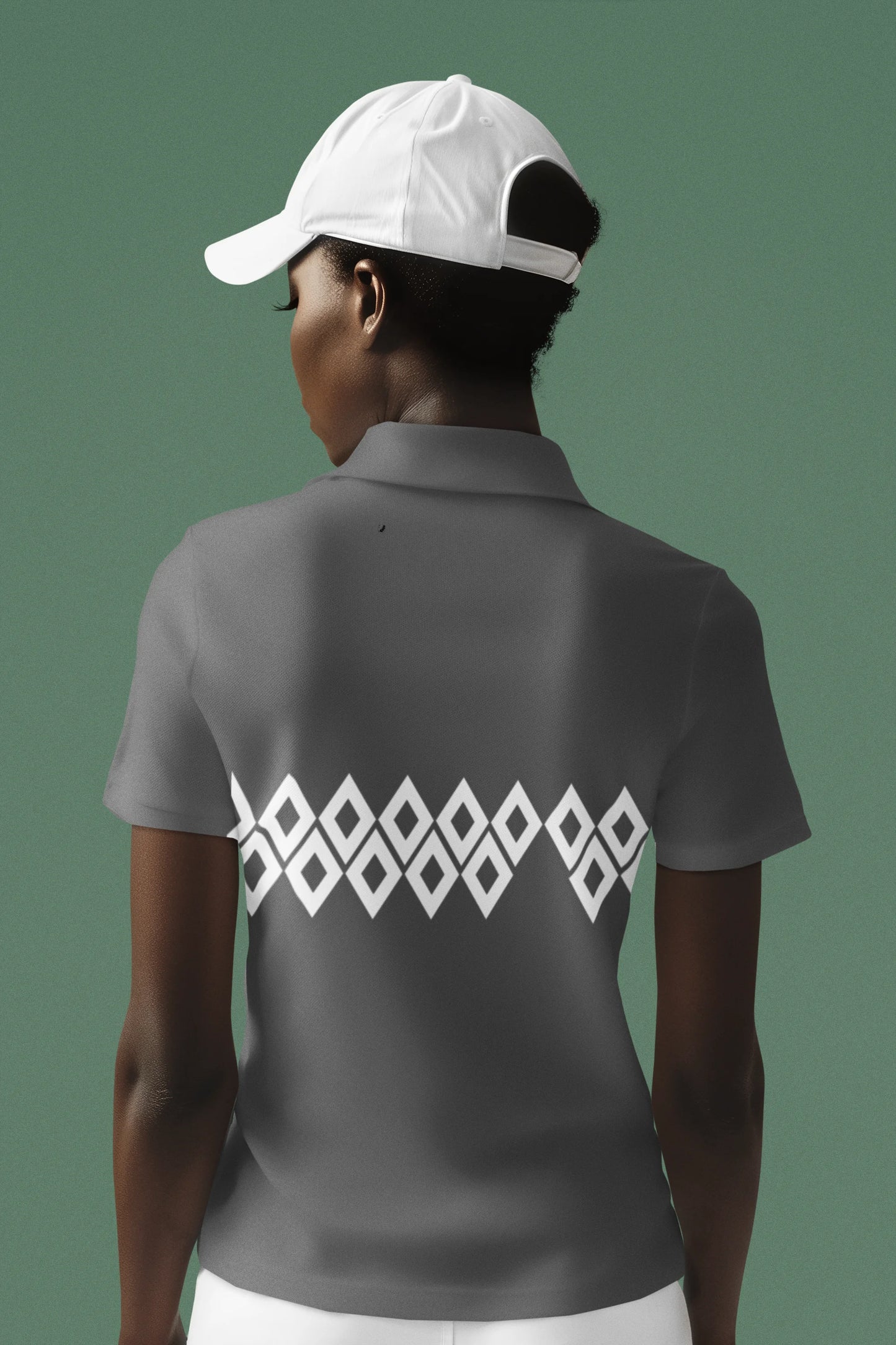 Person wearing a gray polo shirt with a white geometric pattern on the back