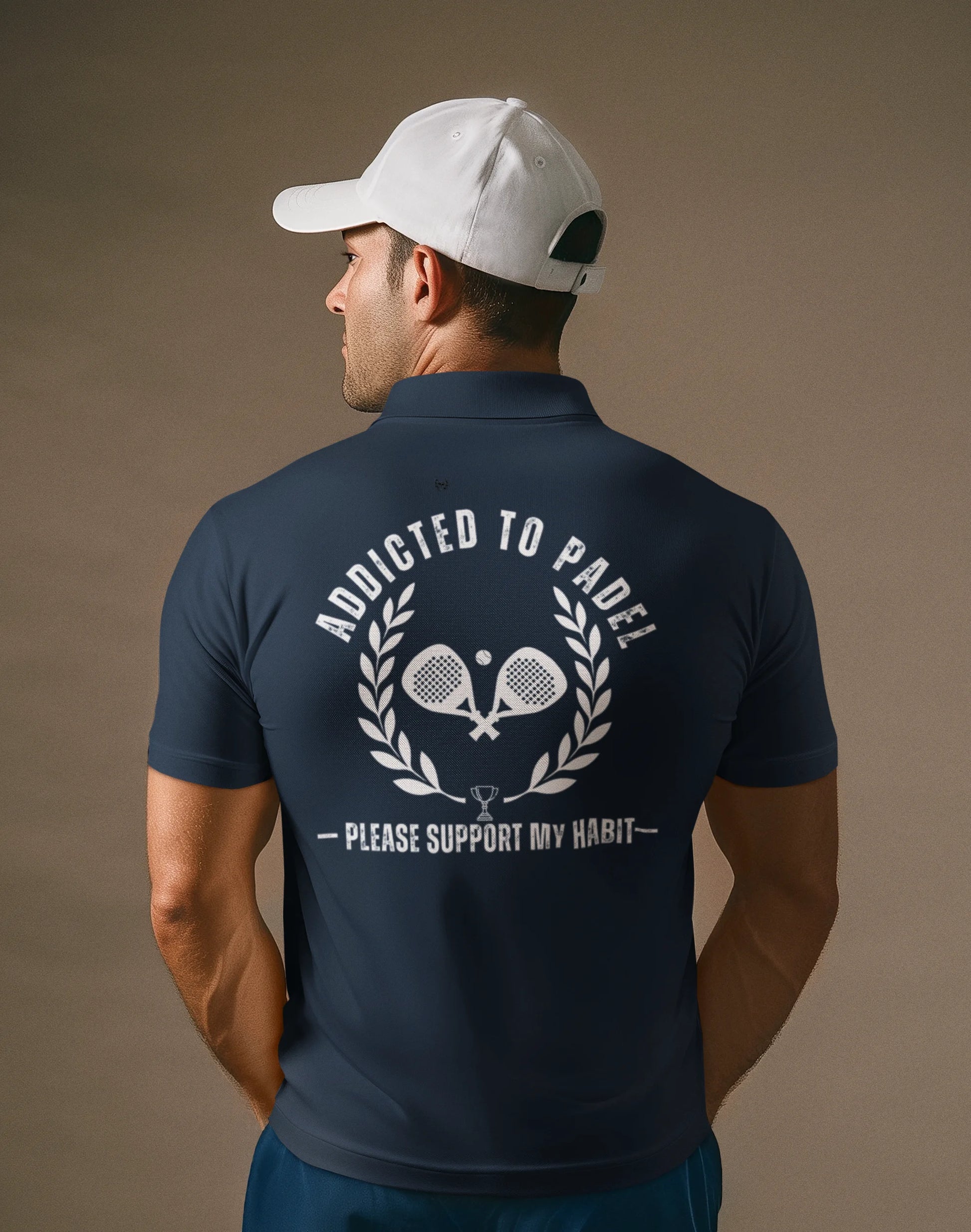 Man wearing a navy blue polo shirt with text and graphics on the back, against a brown background