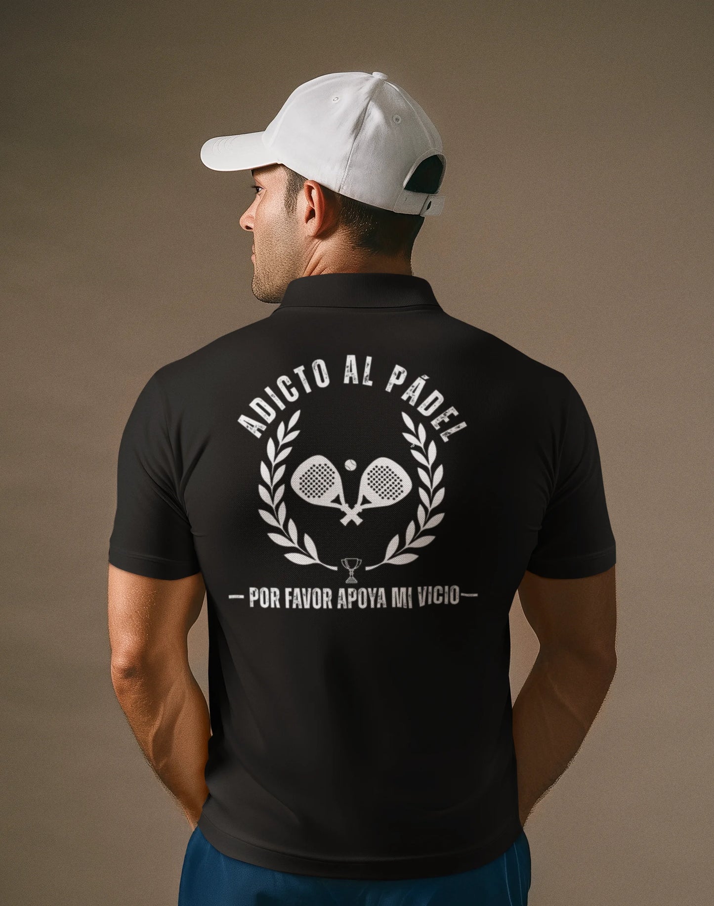 Man wearing a black polo shirt with white text and graphics on the back, against a brown background.