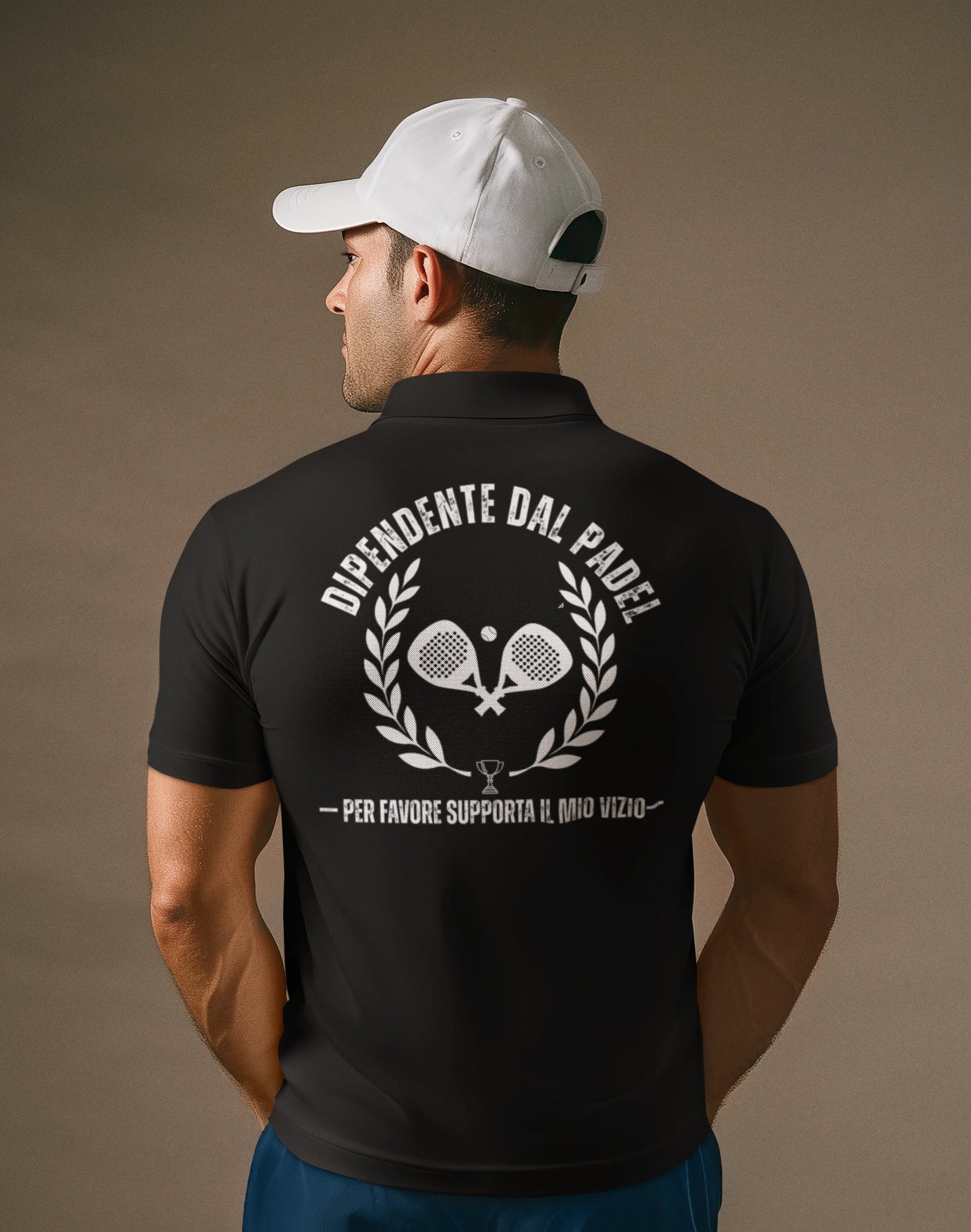 Man wearing a black polo shirt with white text and graphics on the back, against a brown background.