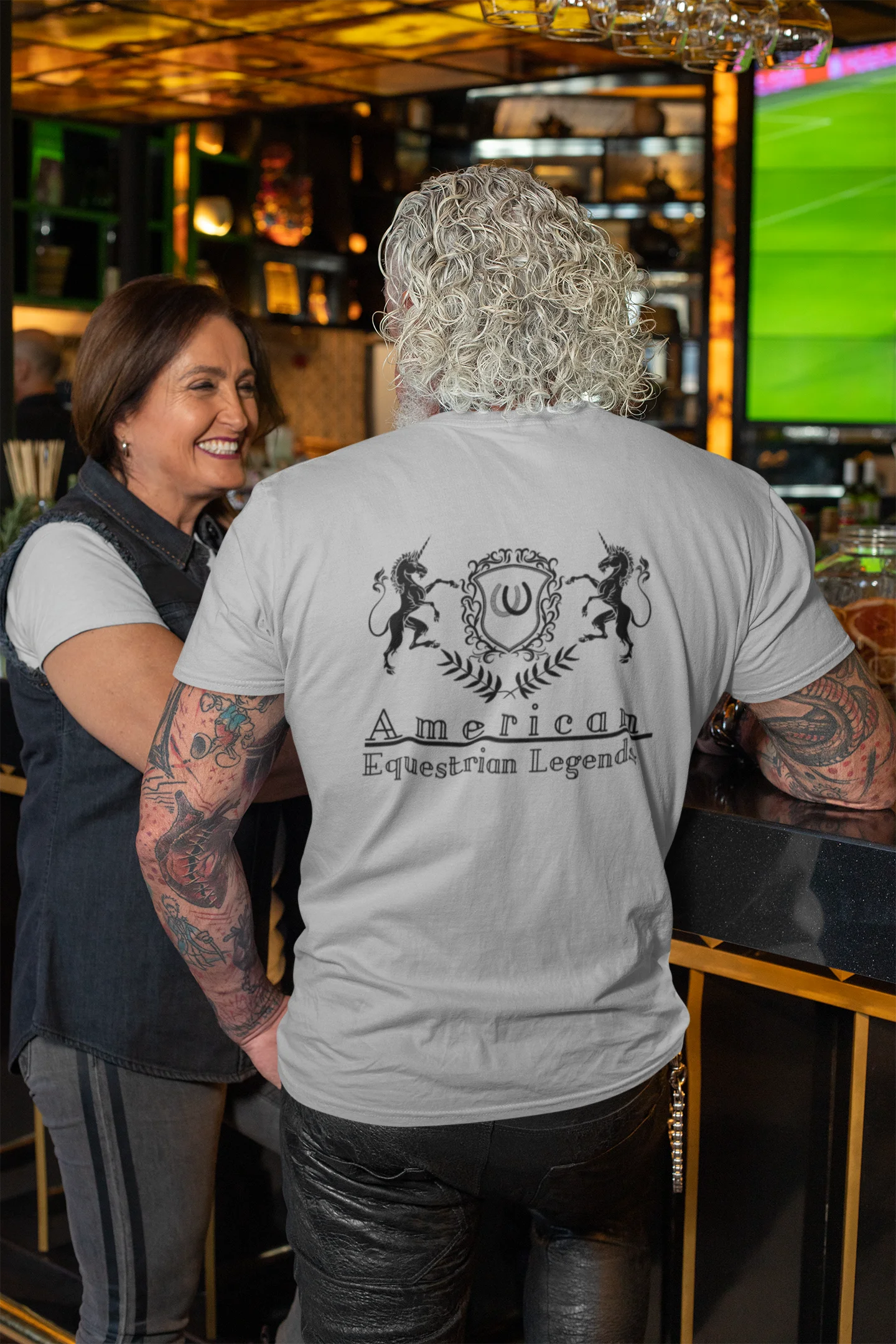 Person wearing a 'American Equestrian Legend' shirt in a bar setting