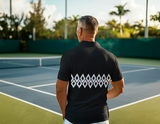 Man wearing a black shirt with a logo on the back, standing on a tennis court.