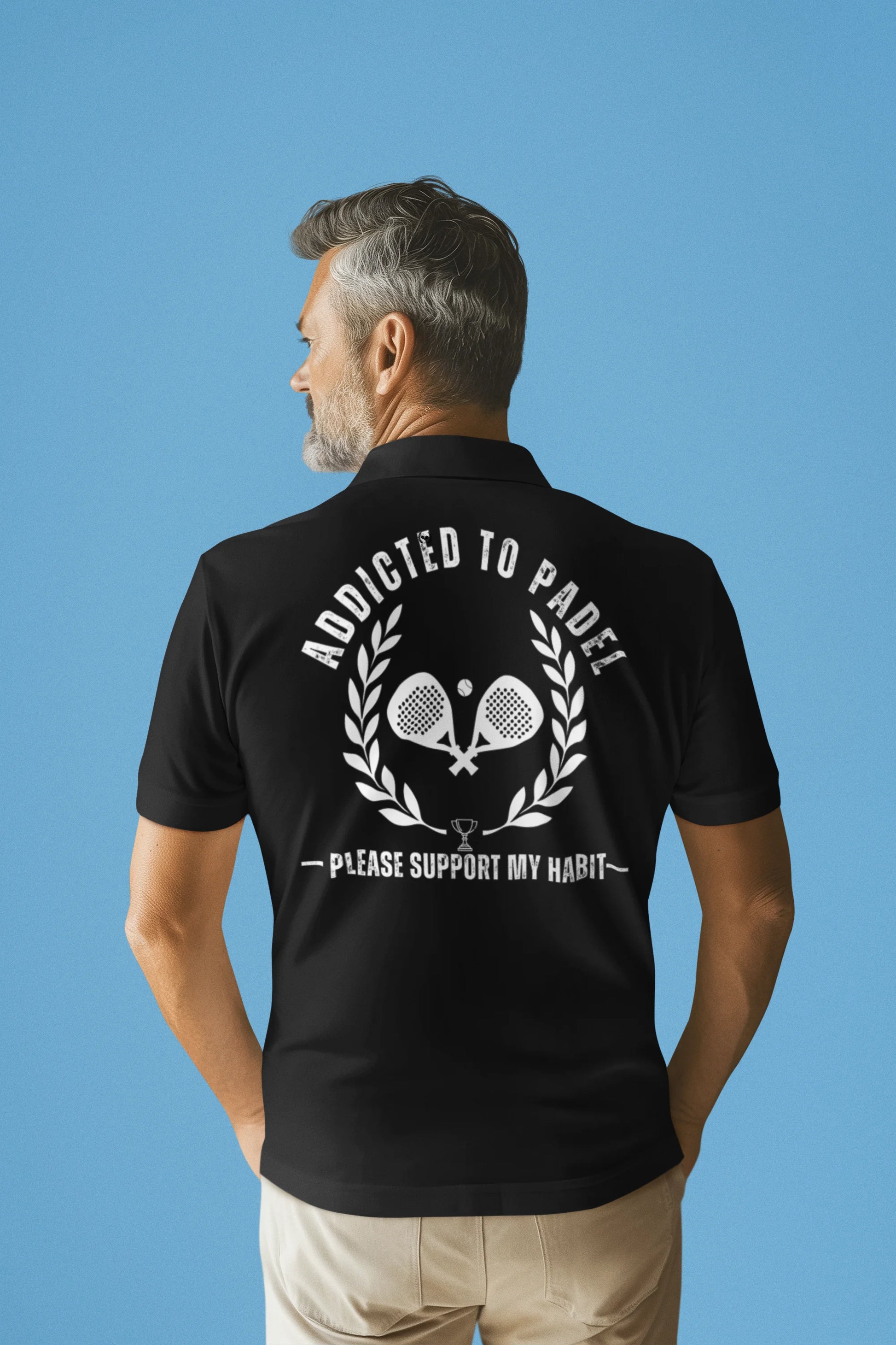 Man wearing a black polo shirt with a graphic and text on the back against a blue background