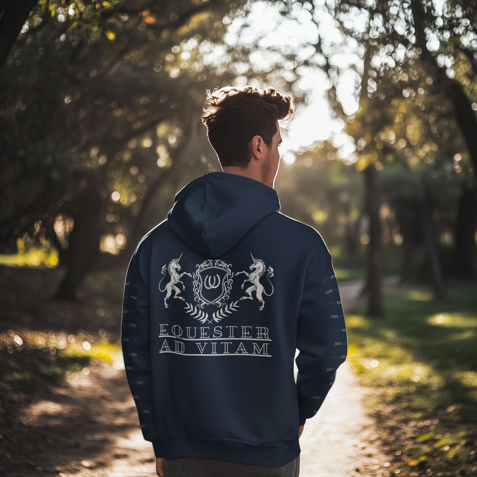 Person wearing a hoodie with a design and text in a forest