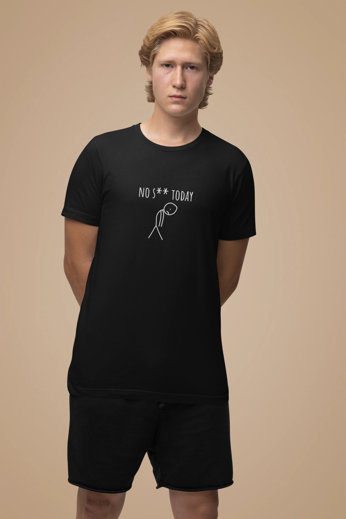 Person wearing a black t-shirt with text and graphics on a beige background