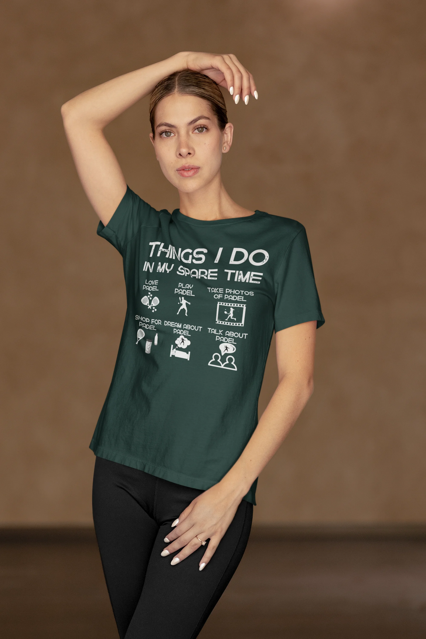 Woman wearing a green t-shirt with text and graphics on a brown background