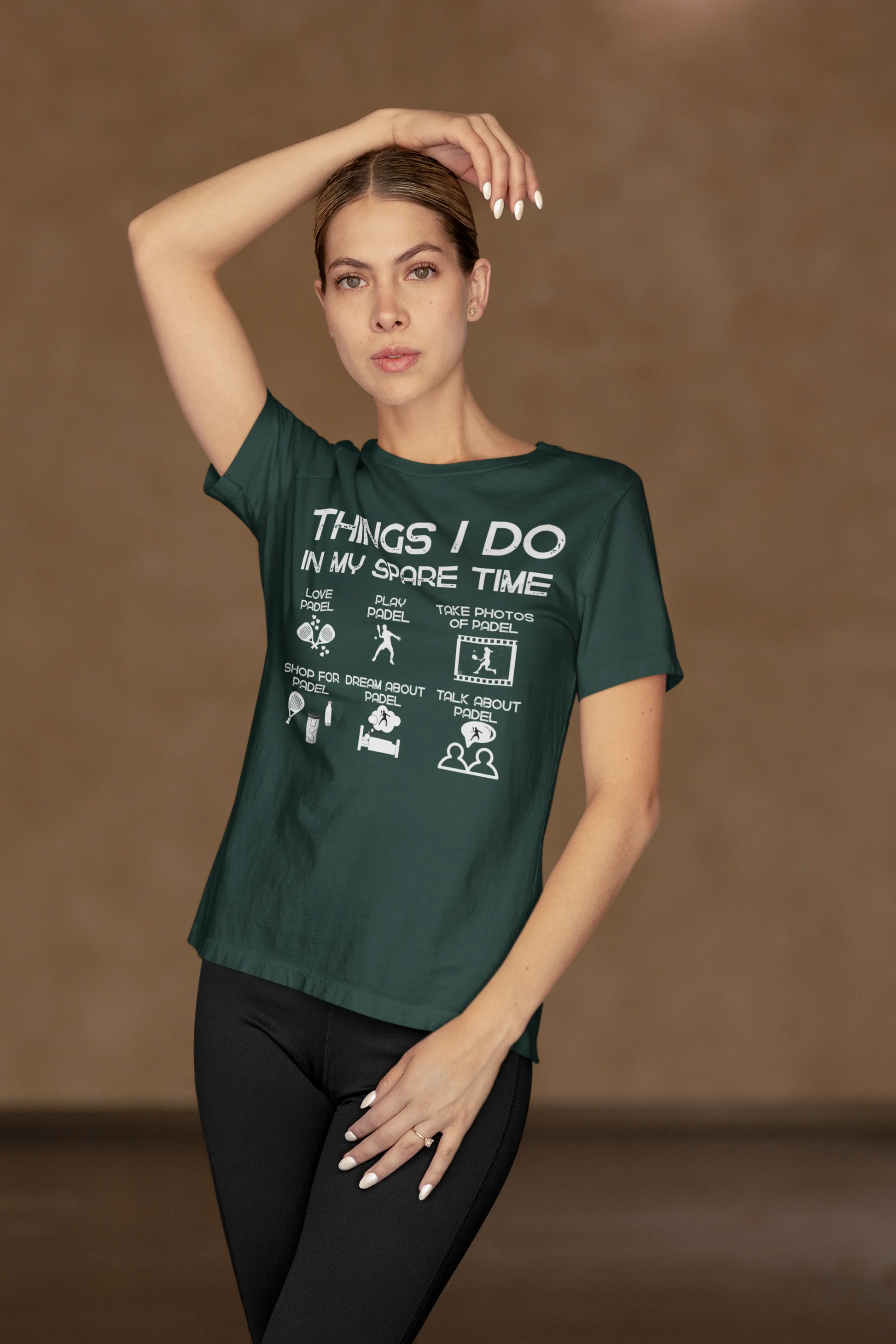 Woman wearing a green t-shirt with text and graphics on a brown background