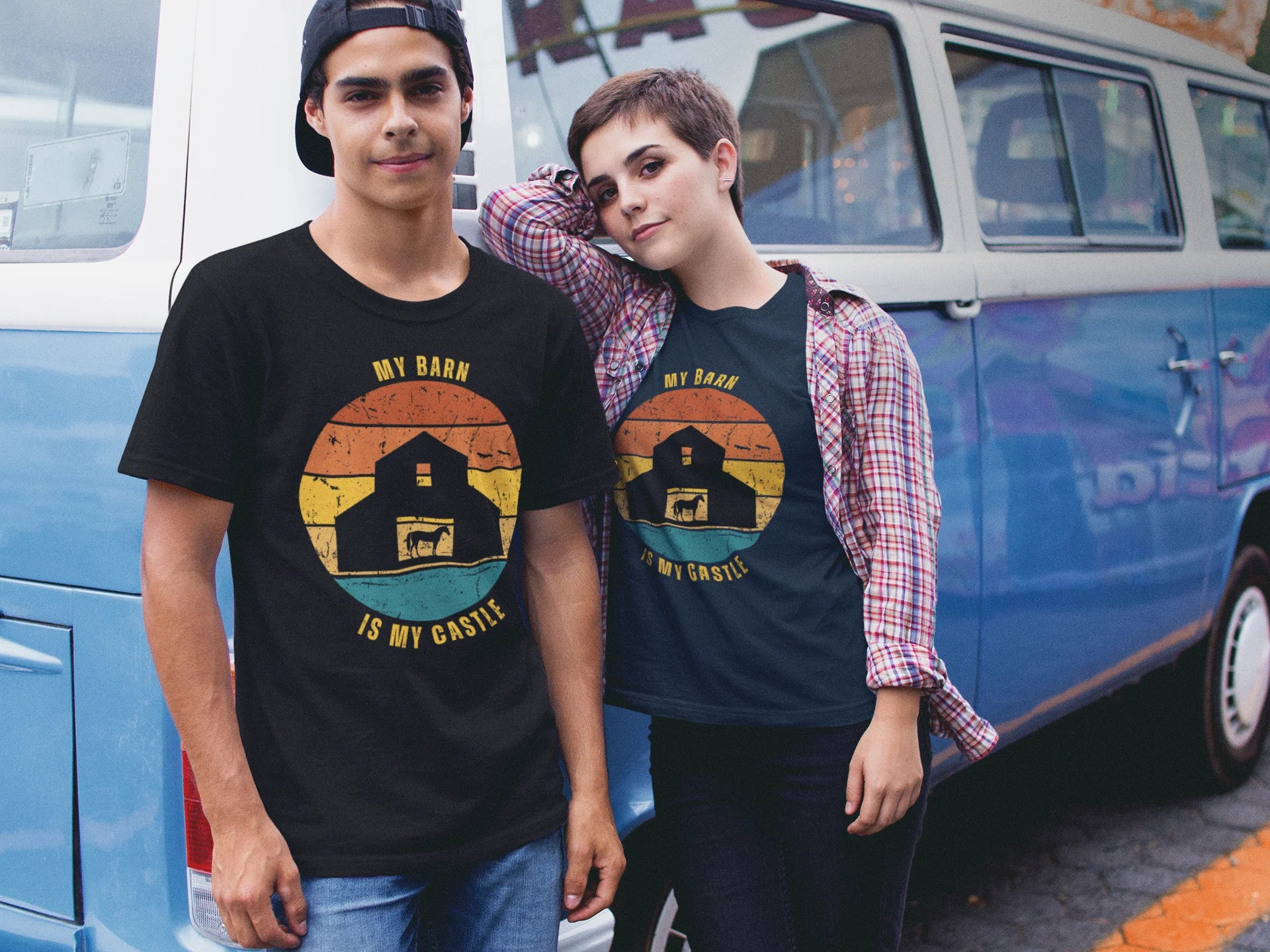 Equestrian Funny Tee Two people wearing t-shirts with a barn graphic design in front of a blue van.