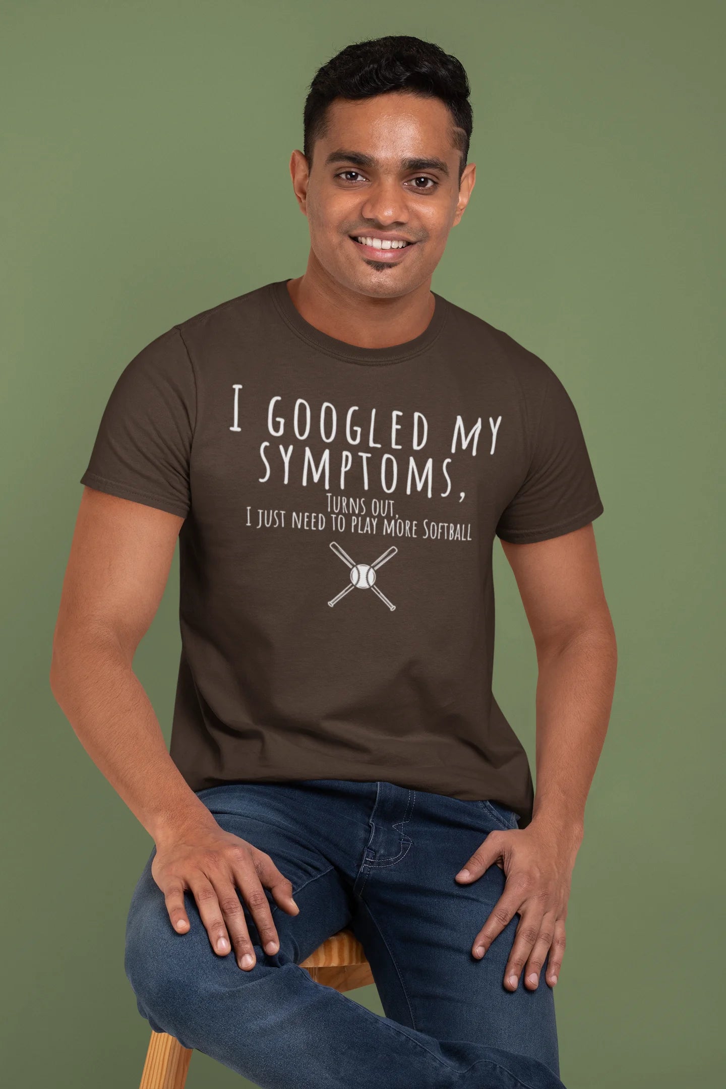 Man wearing a brown t-shirt with humorous text on a green background