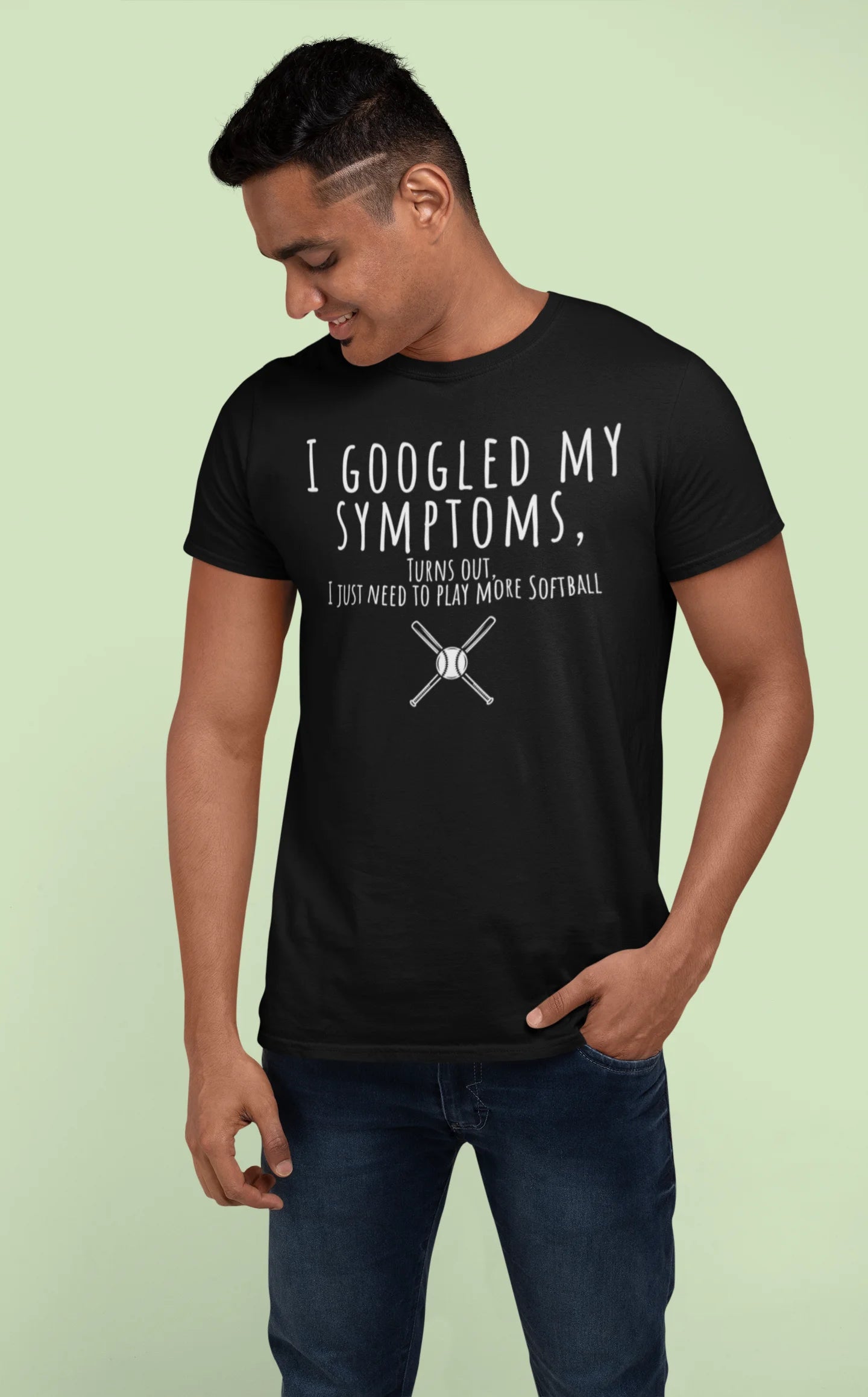 Man wearing a black t-shirt with humorous text and graphic on a light green background