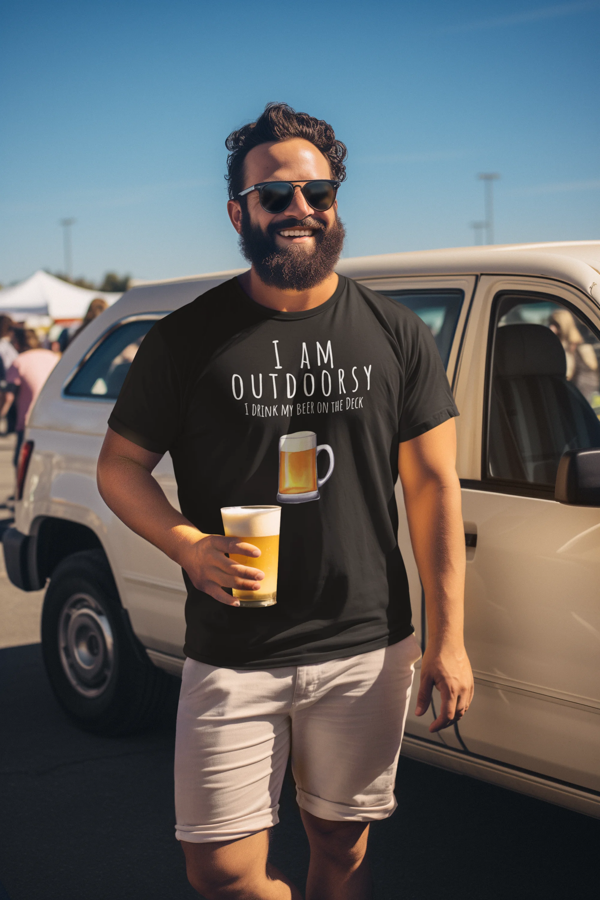 Man wearing a black t-shirt with a graphic and text, holding a beer, standing next to a white van.