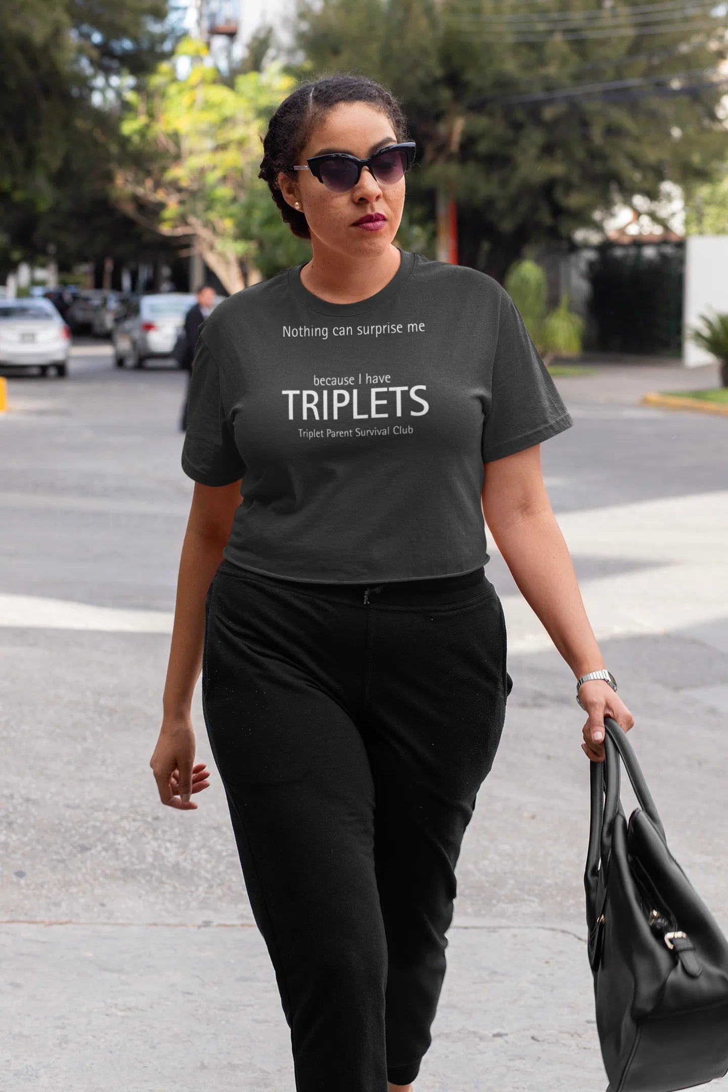 Triplet Gifts Woman walking outdoors wearing a t-shirt with text