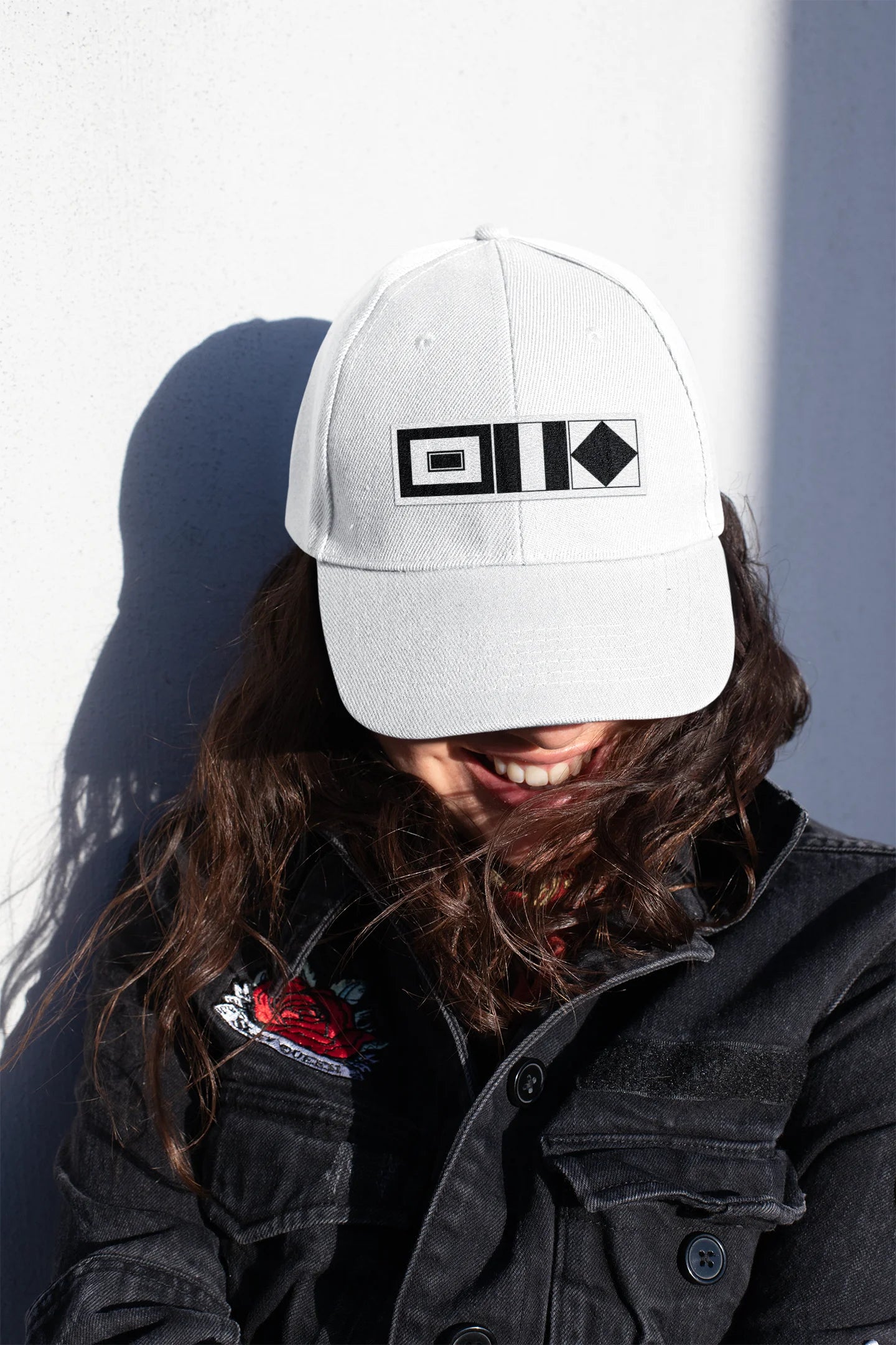 Sailing Cap Person wearing a white cap with an eye design against a plain background