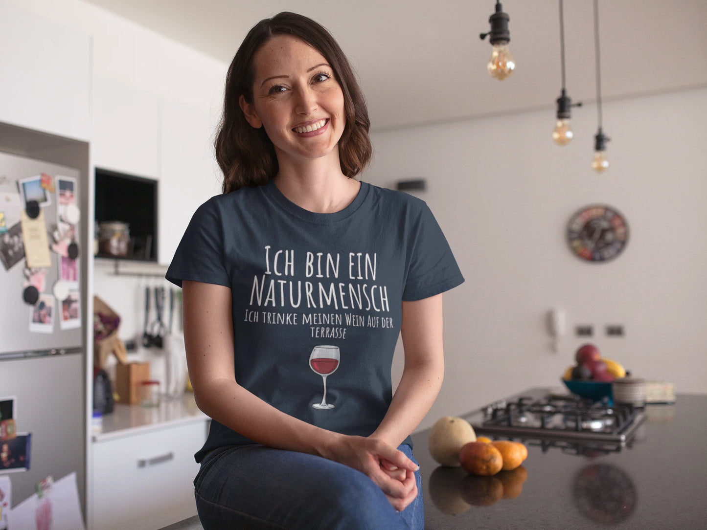 Woman wearing a t-shirt with German text in a kitchen