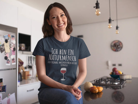 Woman wearing a t-shirt with German text in a kitchen
