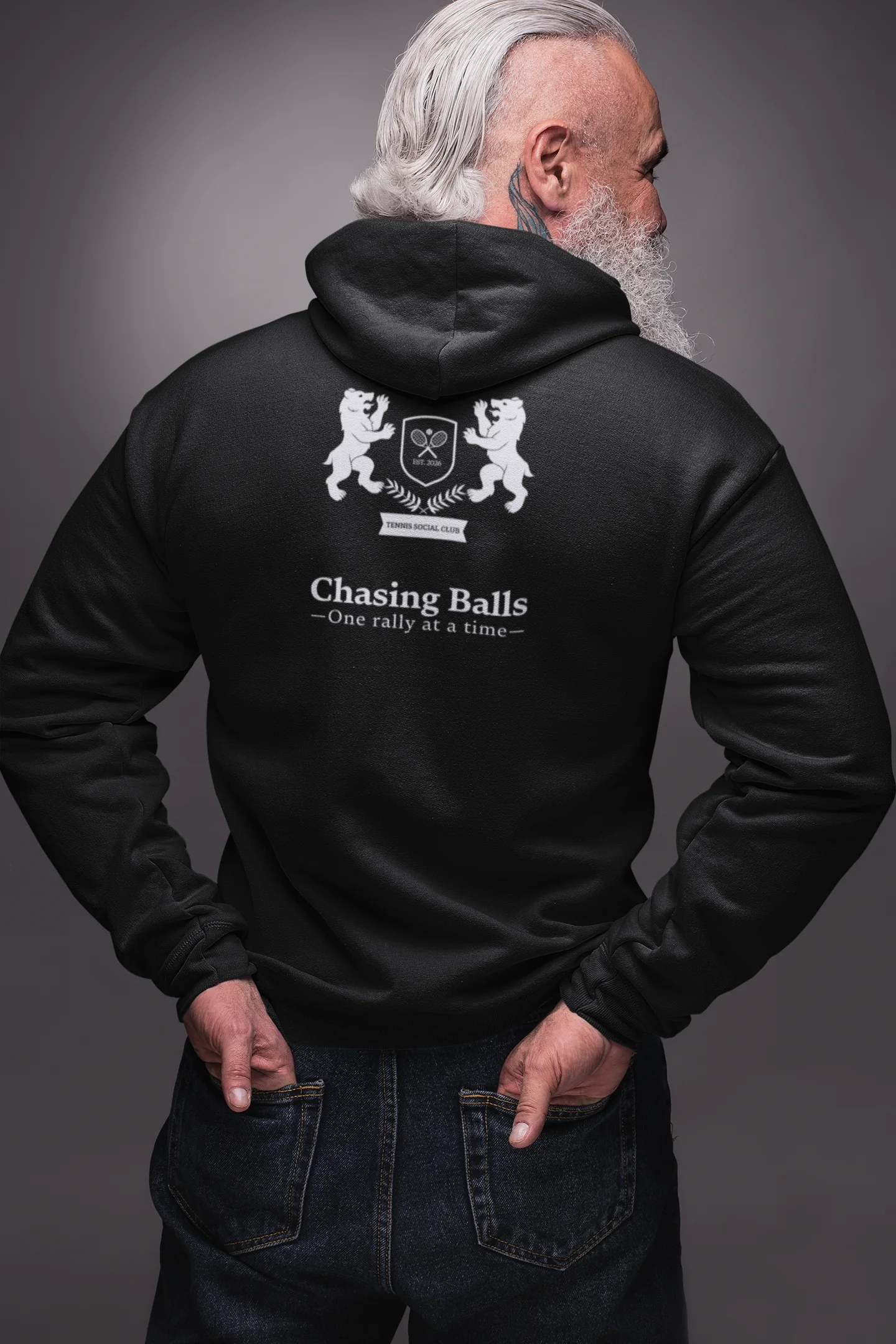 Man wearing a black hoodie with text and graphics on the back against a gray background