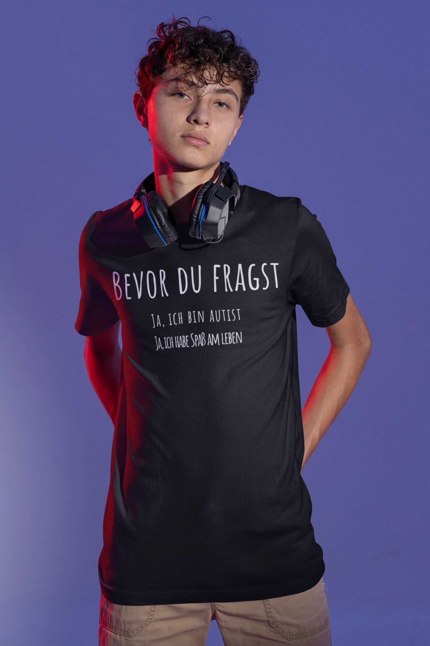 Person wearing a black t-shirt with text against a purple background