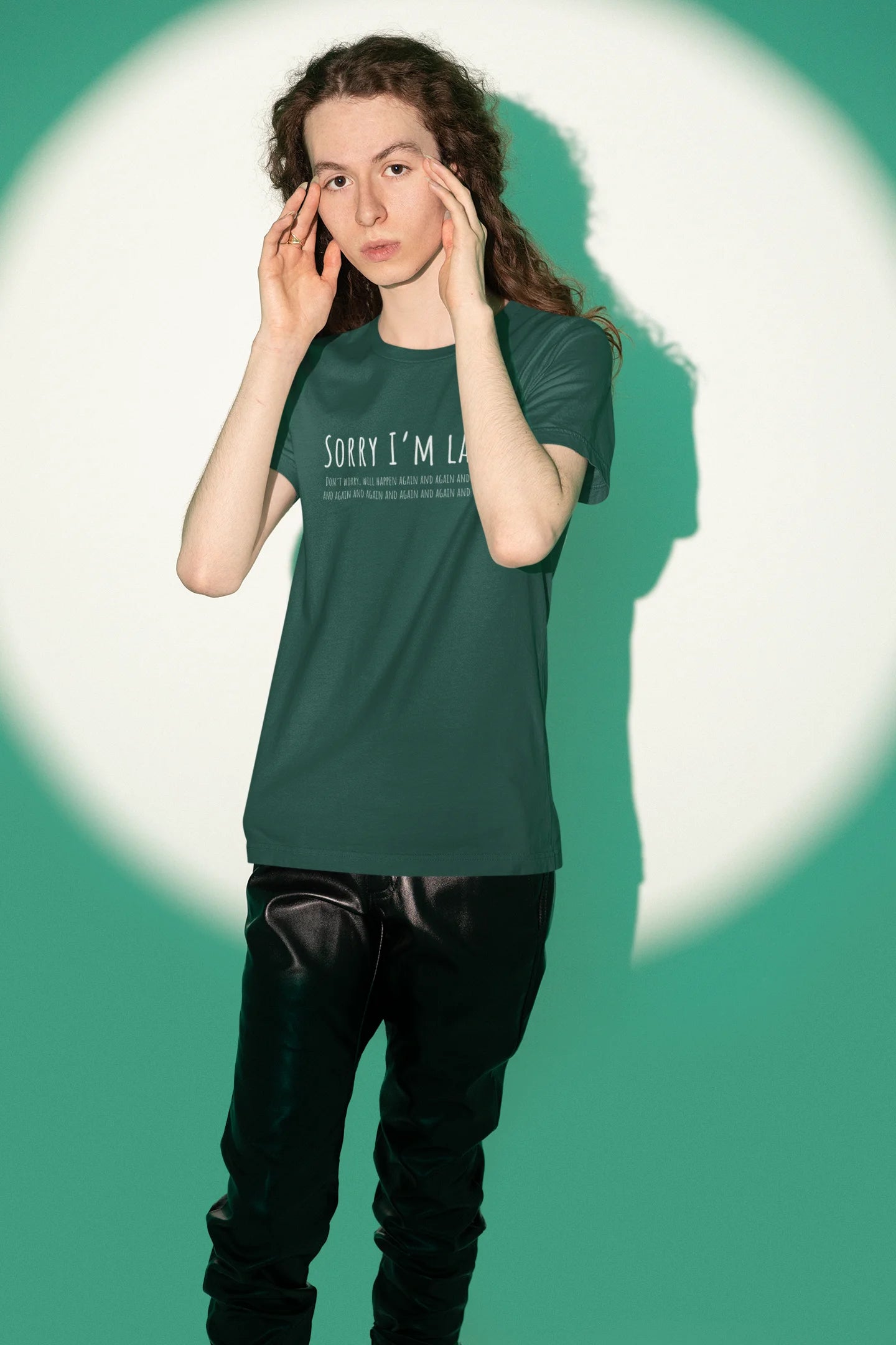 Person wearing a green t-shirt with text on a green background
