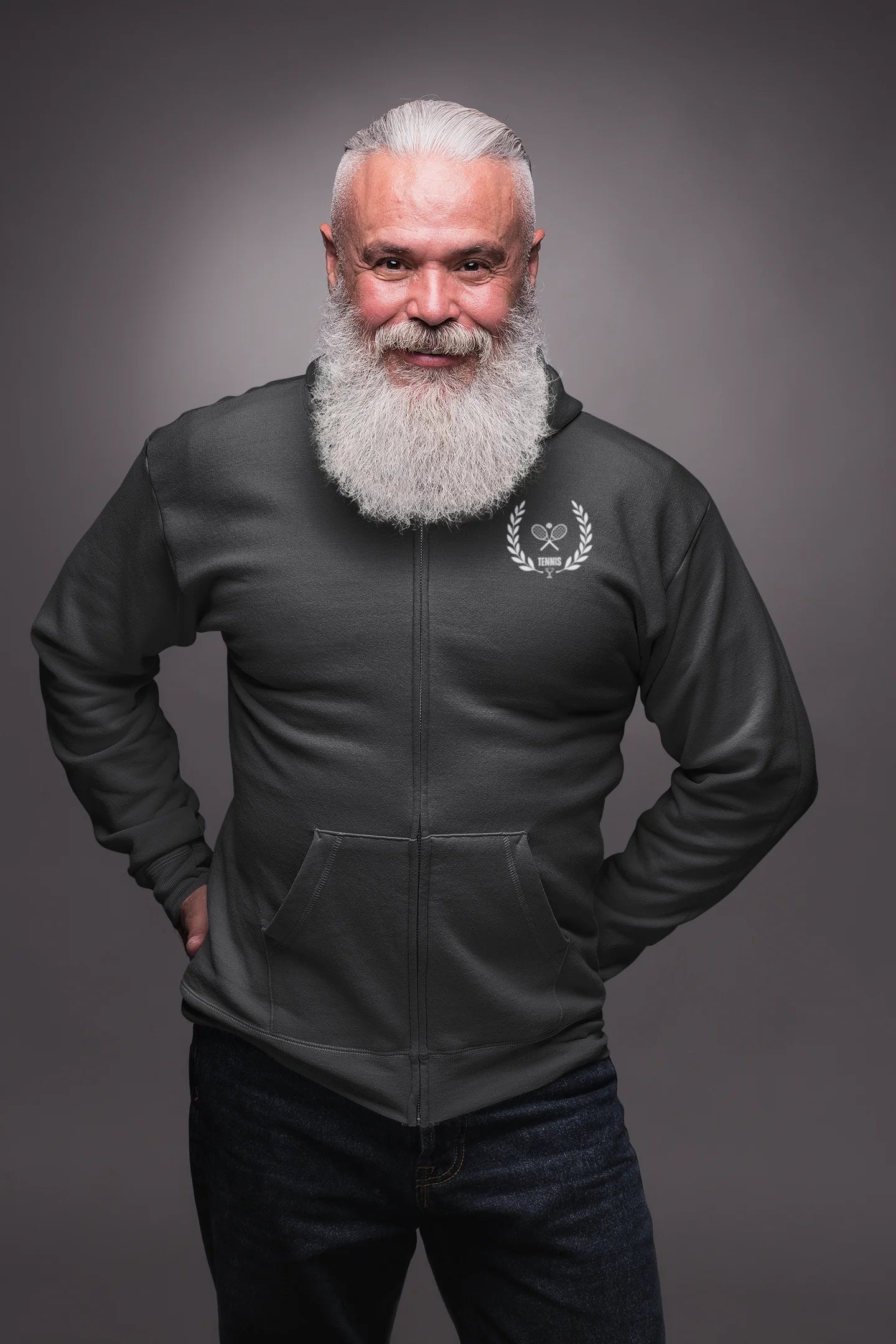 Man wearing a dark gray jacket with a logo on a gray background