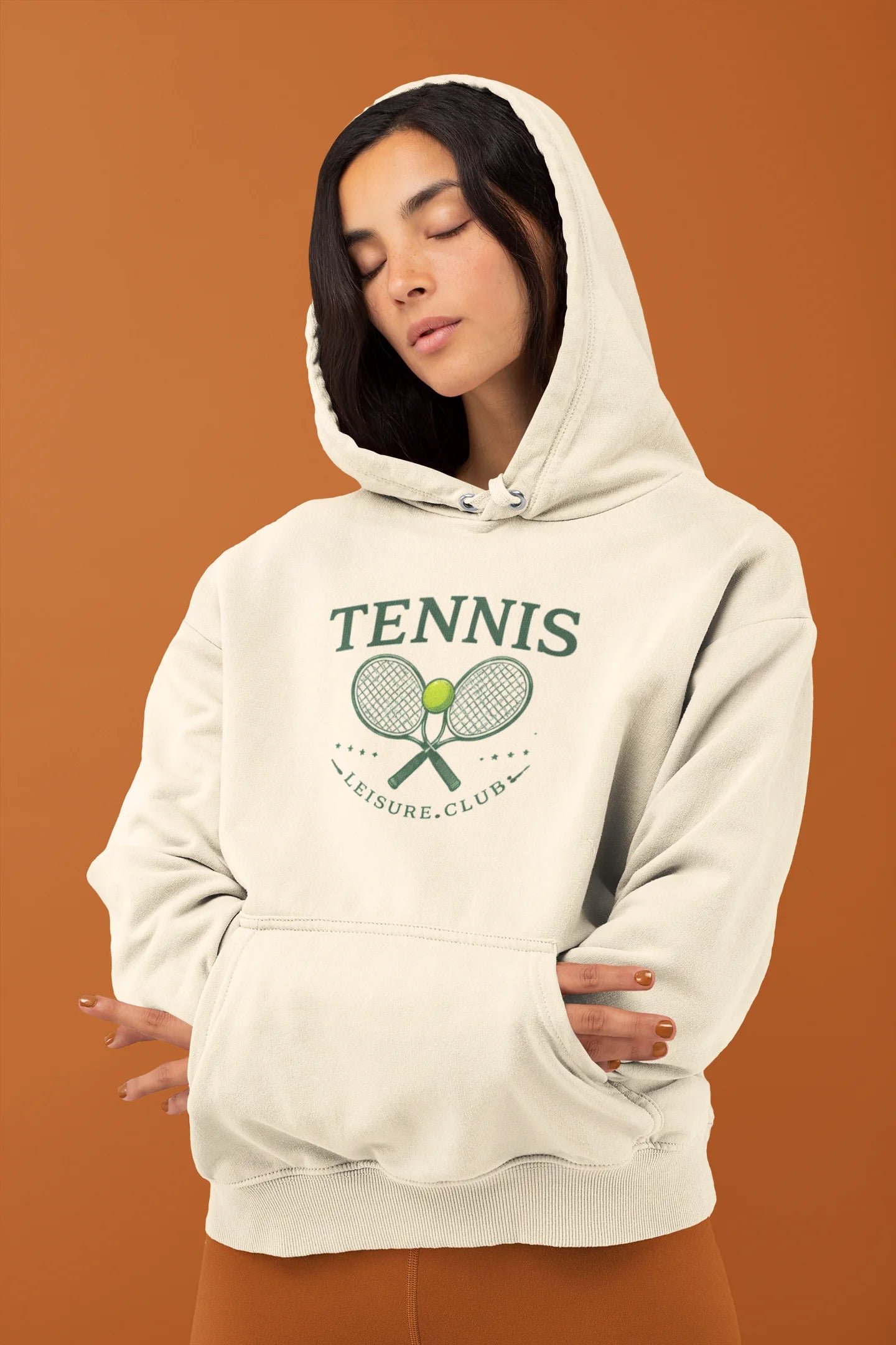 Person wearing a white hoodie with 'Tennis Leisure Club' design on an orange background