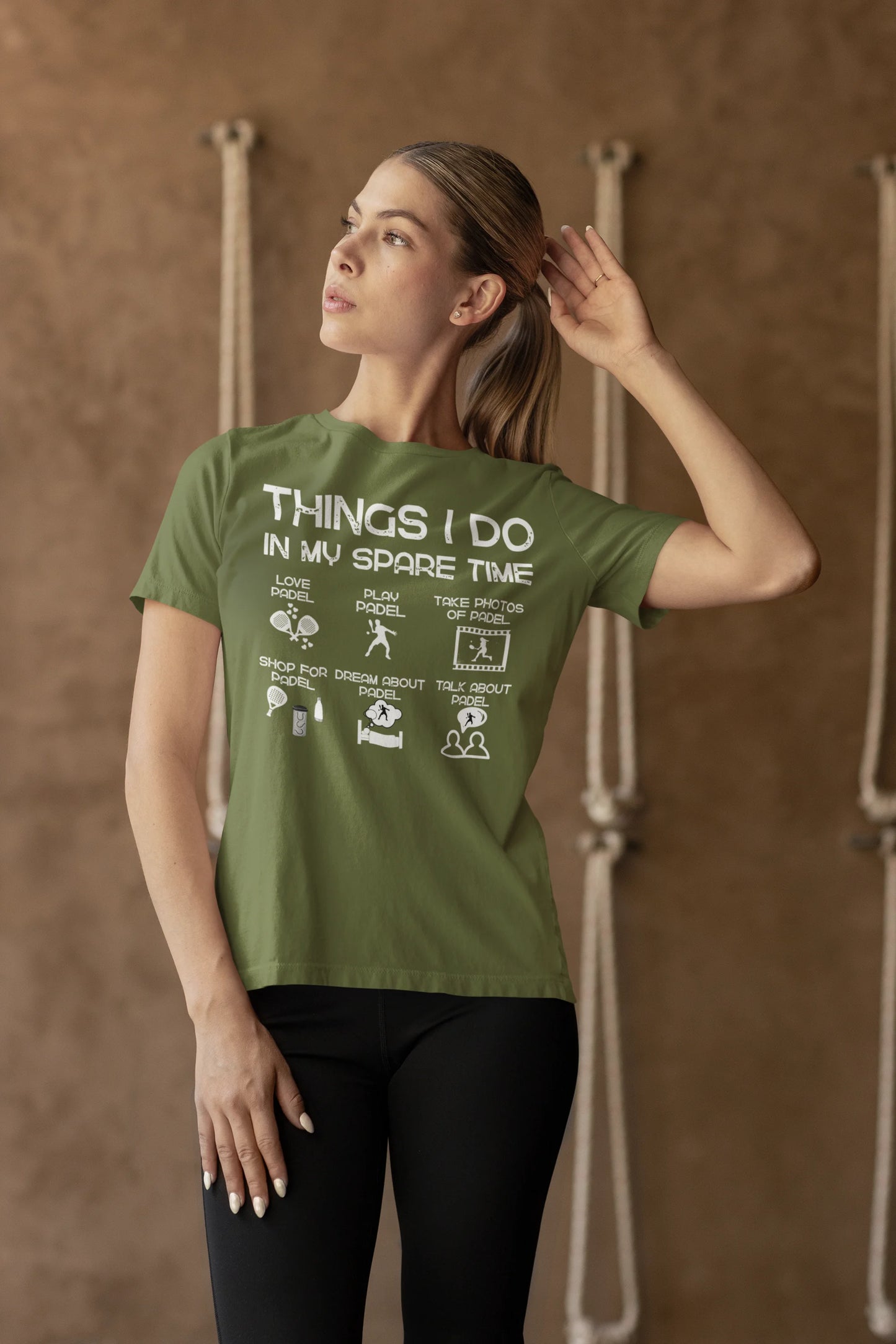 Woman wearing a green t-shirt with text against a brown background