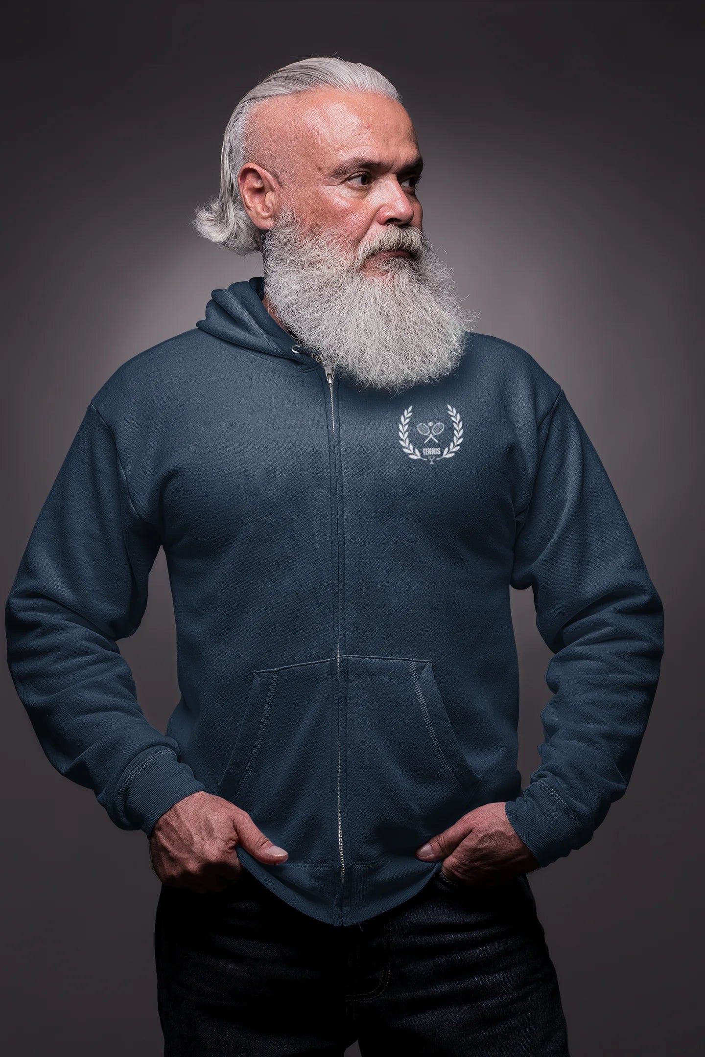 Man wearing a blue hoodie with a logo on a dark background