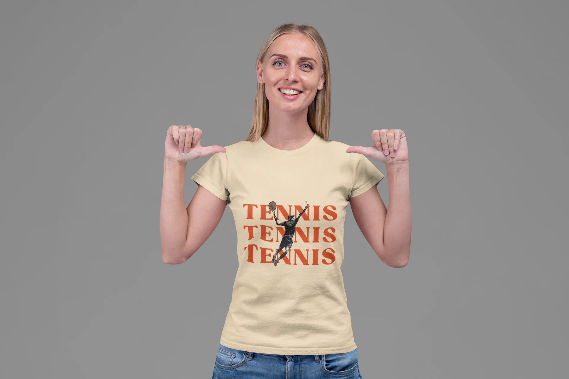 Woman wearing a beige t-shirt with 'Tennis Tennis Tennis' and a tennis player graphic on a gray background
