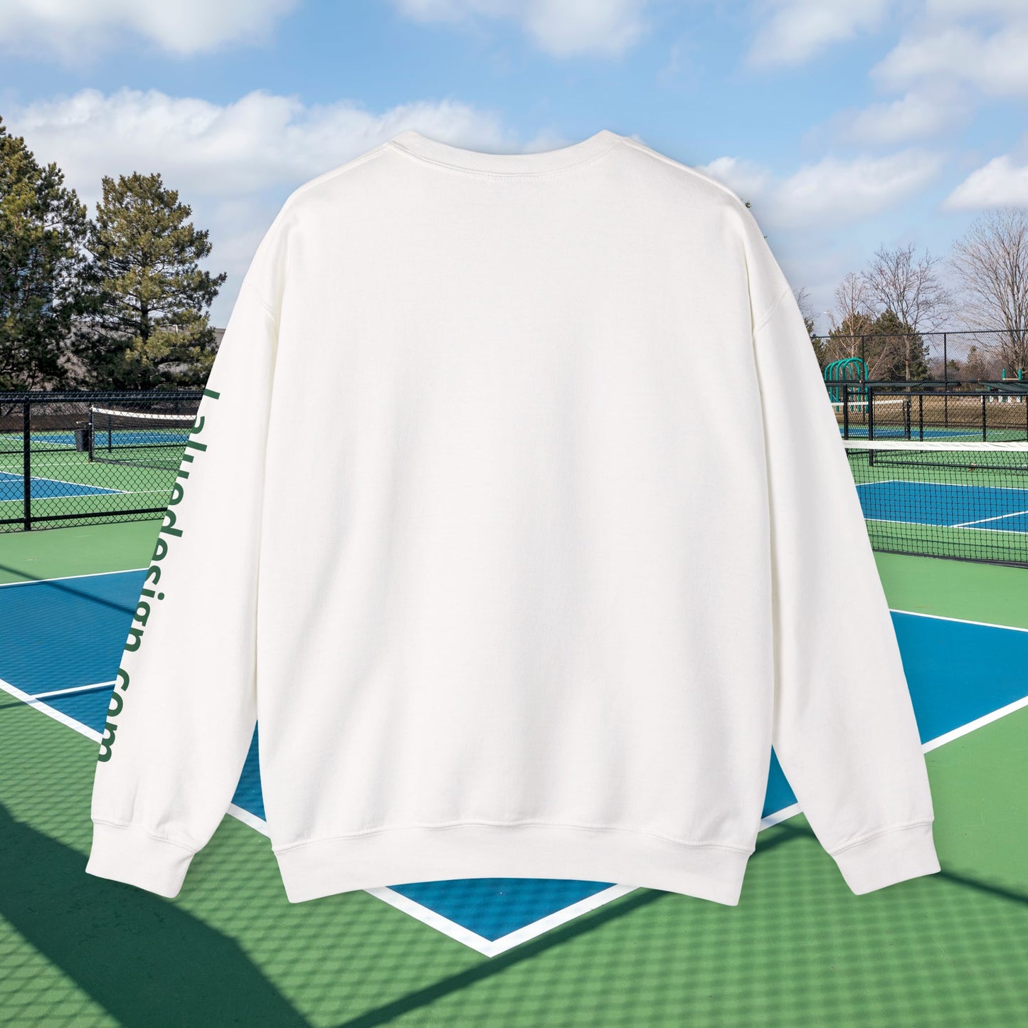 personalized padel gift A white crewneck sweatshirt shown from the back, featuring green vertical text down the left sleeve that reads 'hoolibag.com'.