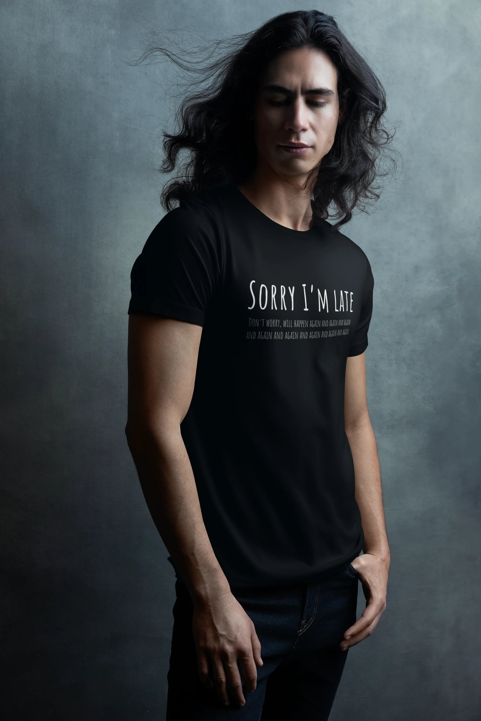 Person wearing a black t-shirt with text against a gray background