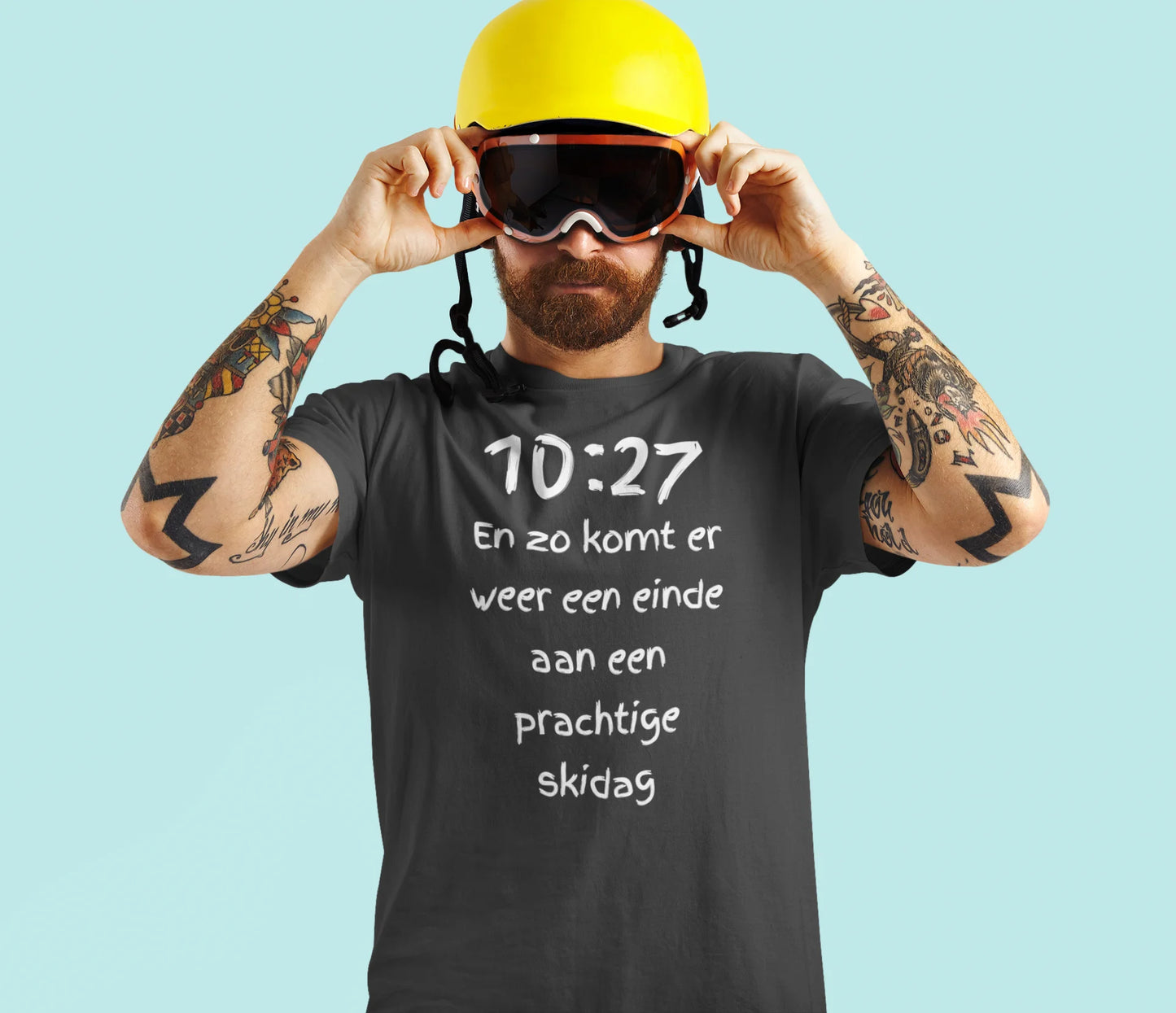 Man wearing a black t-shirt with text, yellow helmet, and goggles on a light blue background