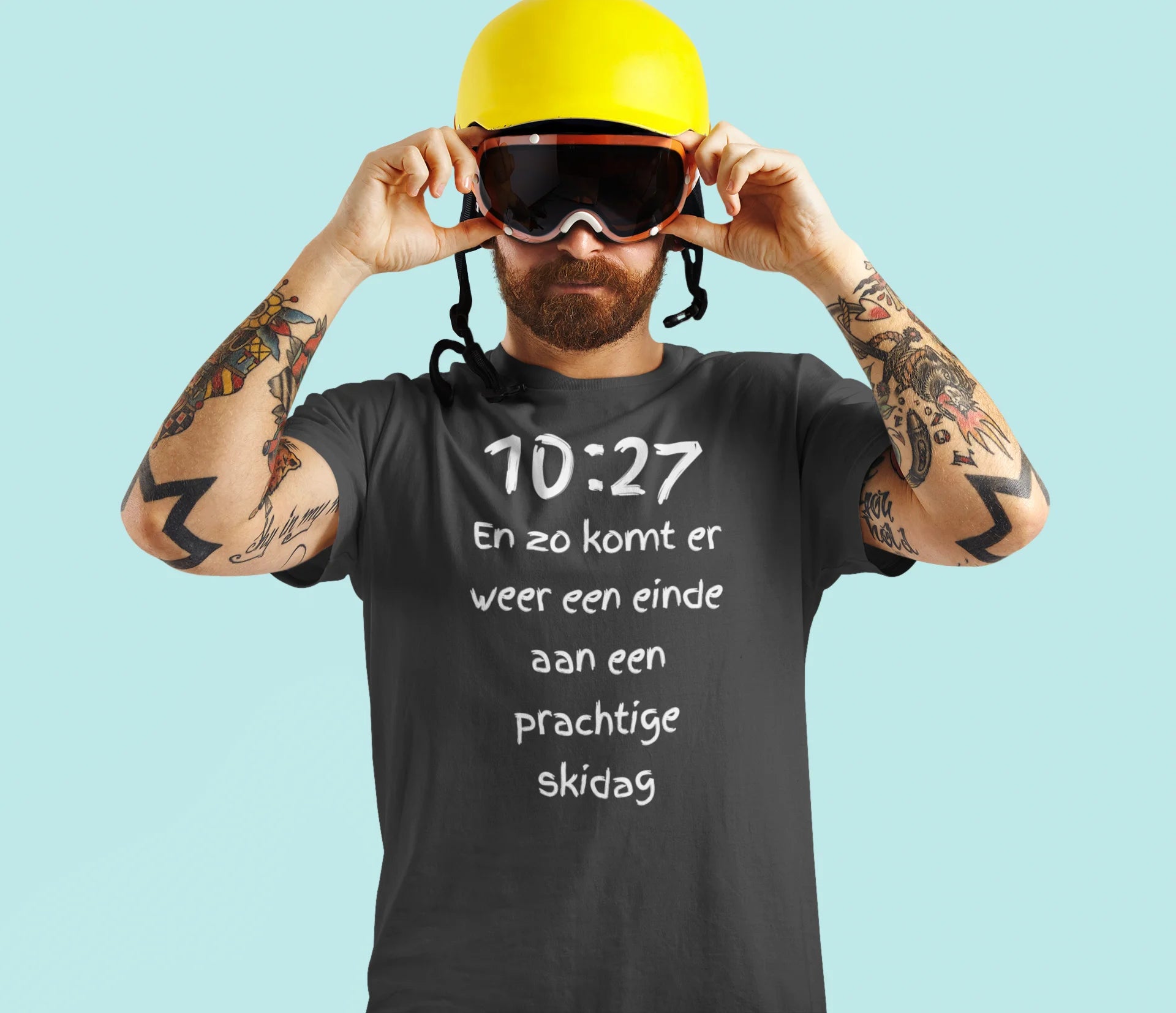 Man wearing a black t-shirt with text, yellow helmet, and goggles on a light blue background