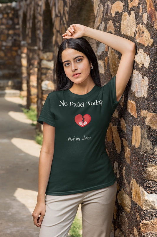 Padel Gift Woman wearing a green t-shirt with a message leaning against a stone wall.