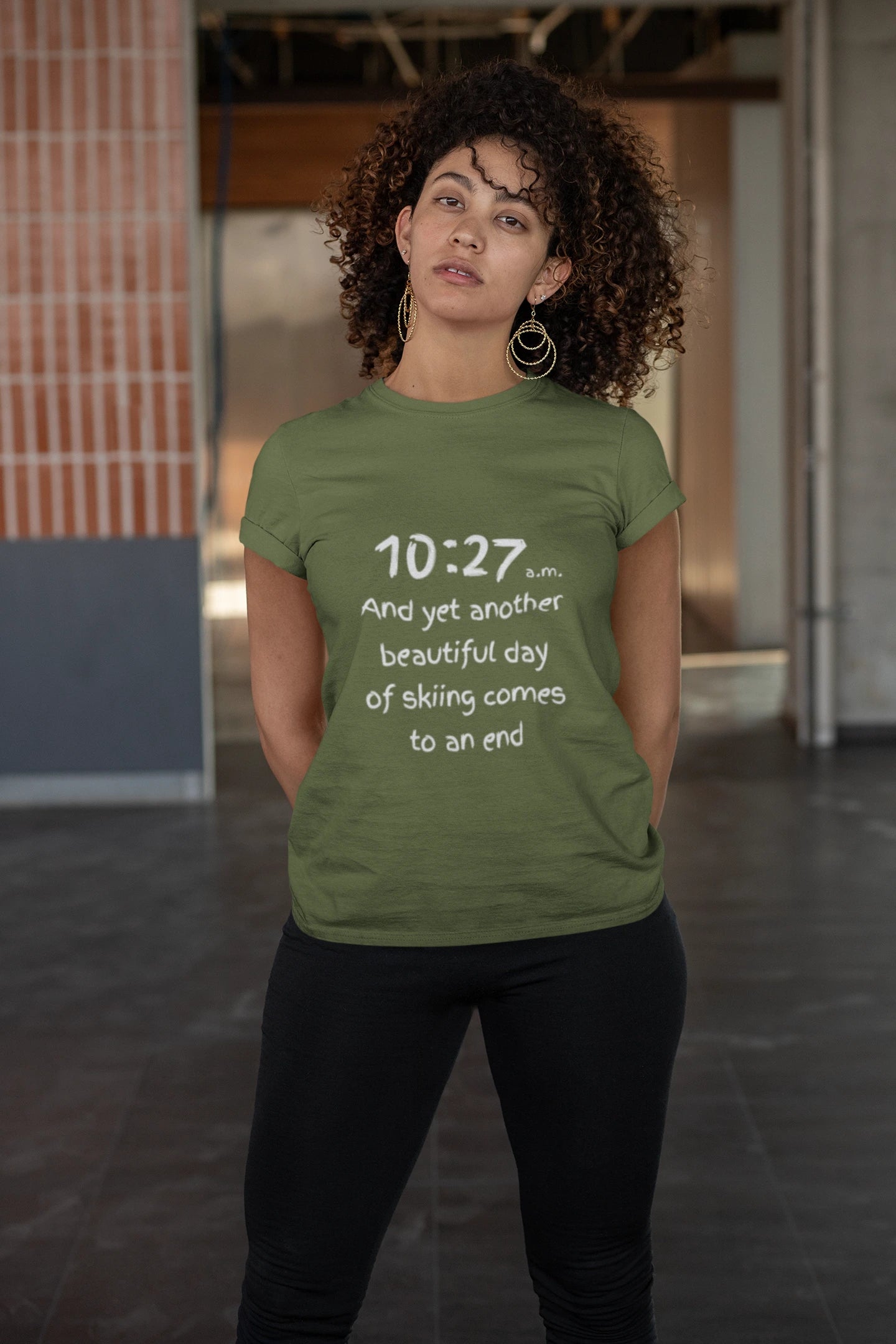 Person wearing a green t-shirt with text in an indoor setting
