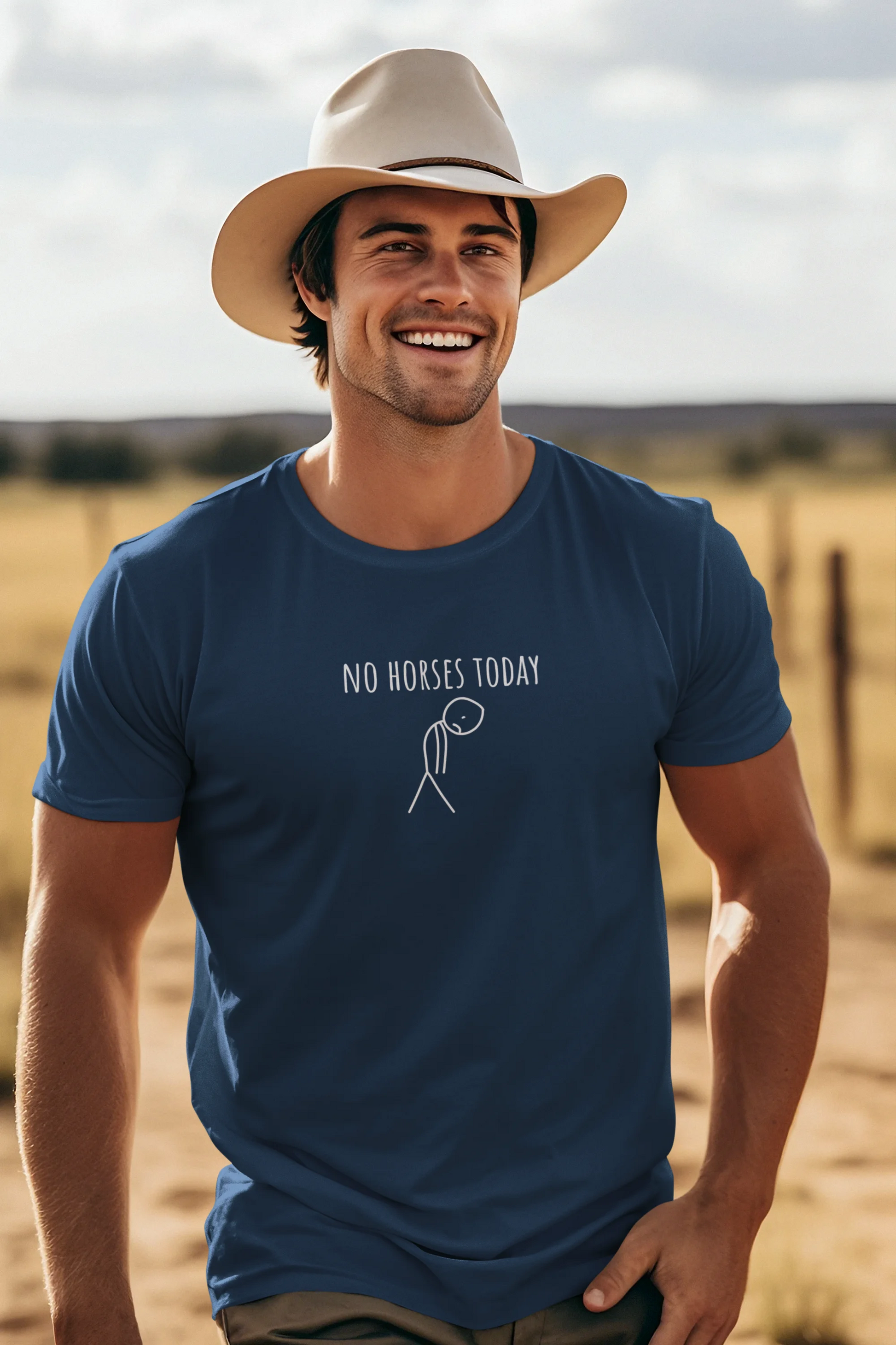 Man wearing a blue t-shirt with 'No Horses Today' text and graphic, standing in a desert landscape.