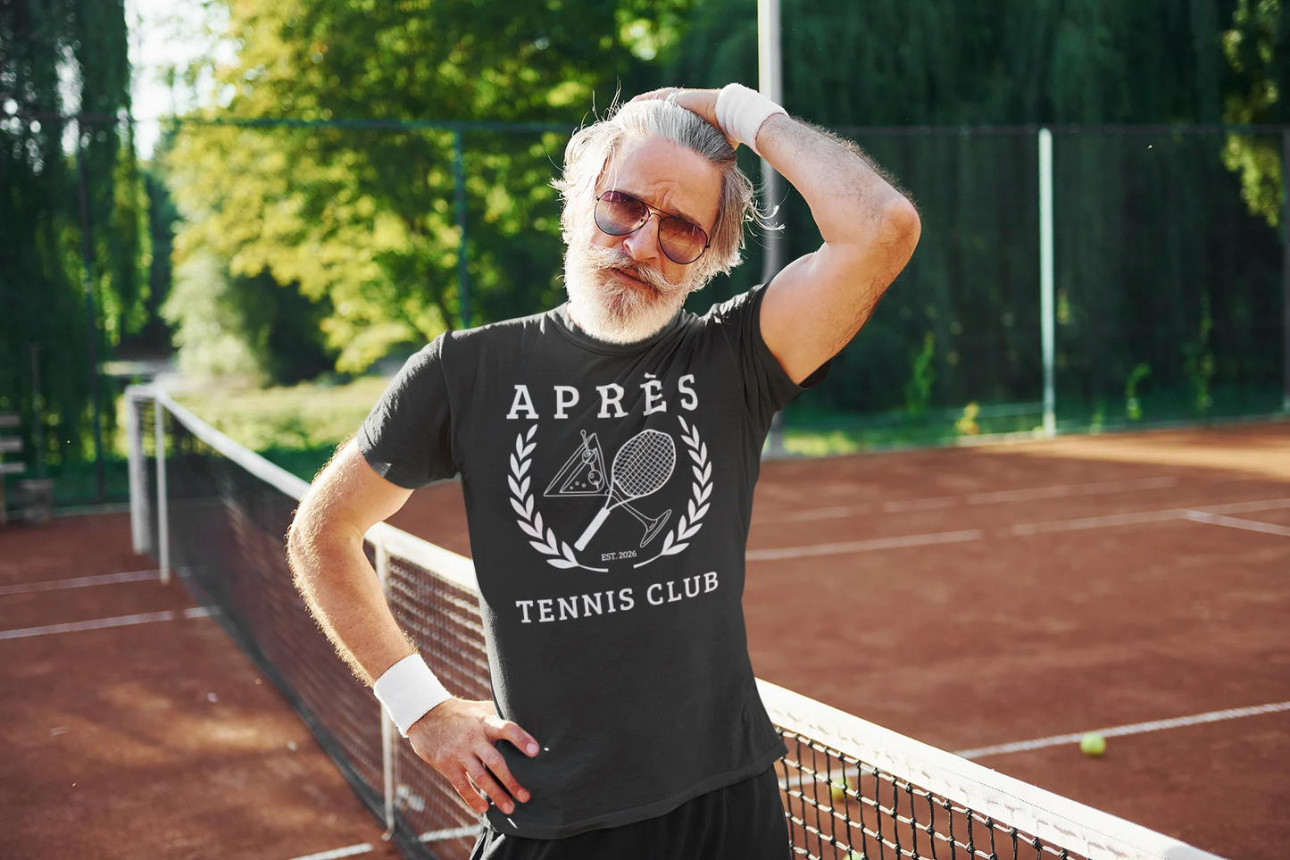 Tennis Club Shirt Man on a tennis court wearing a black t-shirt with 'Apèrs Tennis Club' text.