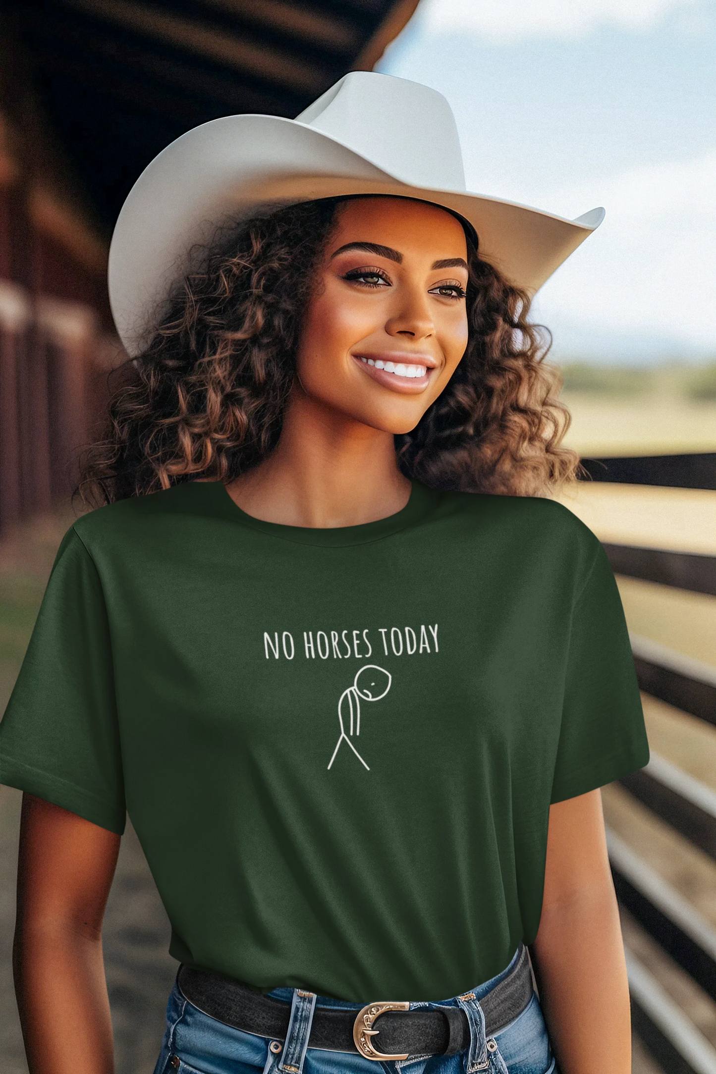 Woman wearing a green t-shirt with 'No Horses Today' text and graphic, standing in a barn.