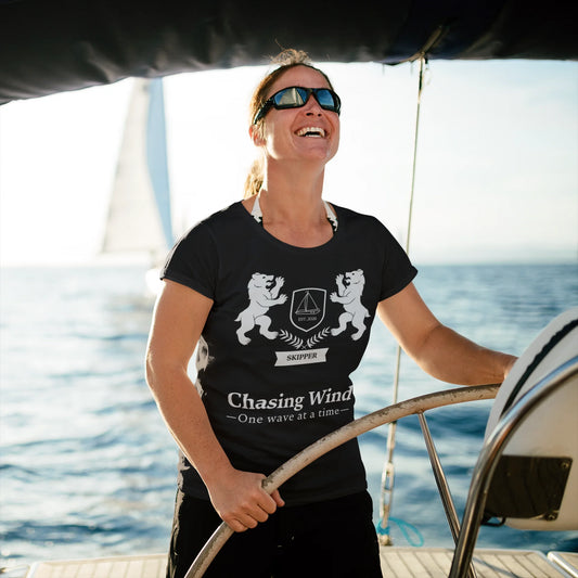 Sailing Boat T Shirt Person on a boat wearing a black t-shirt with a design and text, with water in the background