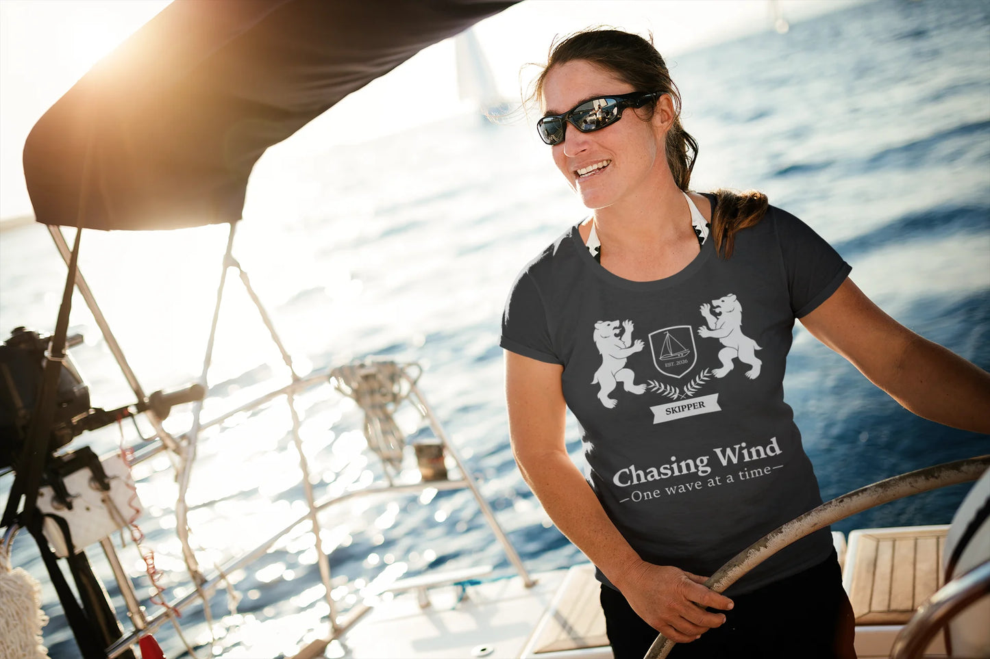 Sailing Boat T Shirt Woman on a sailboat wearing a t-shirt with a design and text.